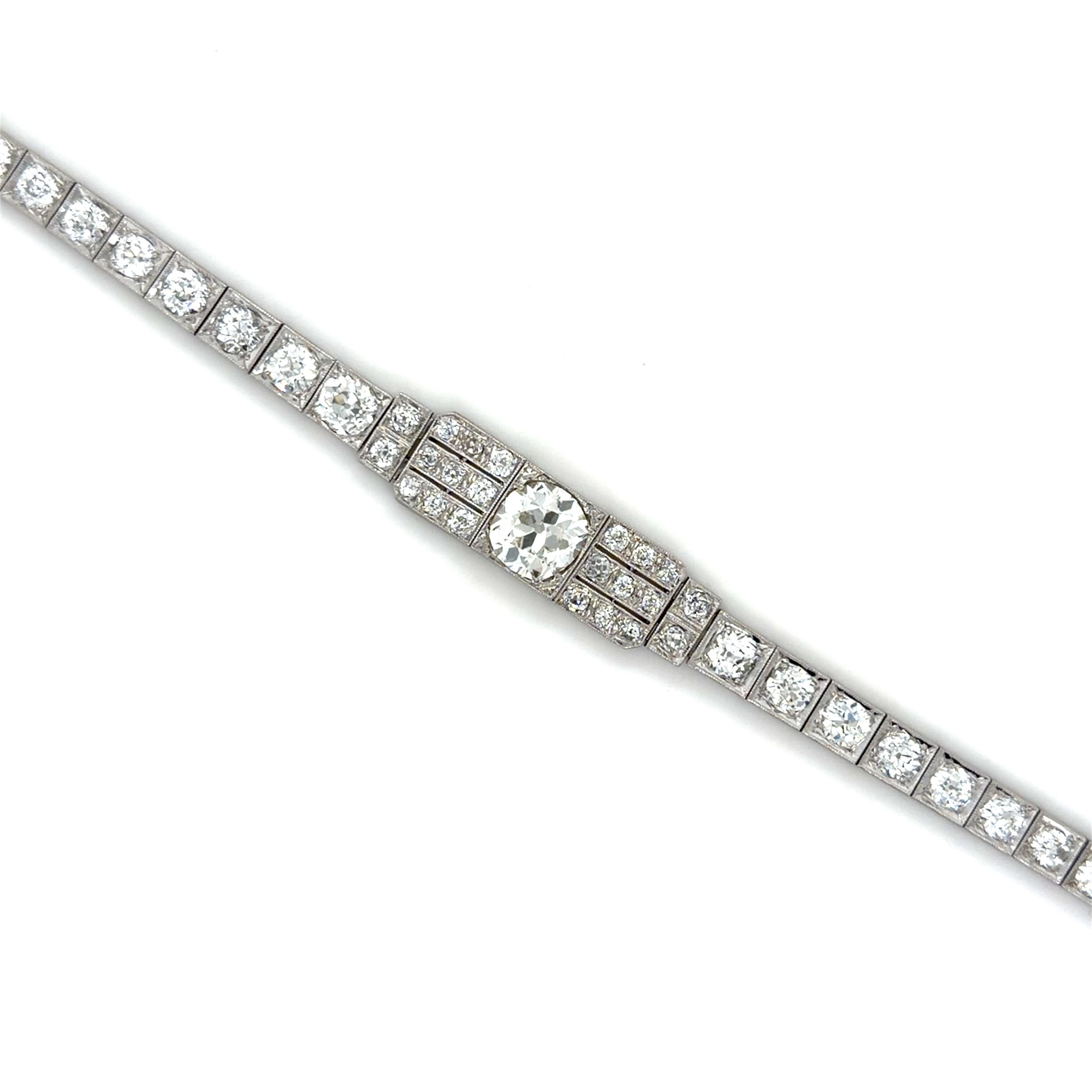 This unique Art Deco bracelet is centered by a beautiful old mine cut diamond weighing 2.35 carats, flanked by numerous old mine and old European cut diamonds weighing approximately 7.00 carats total. Carefully crafted in platinum, and beautifully