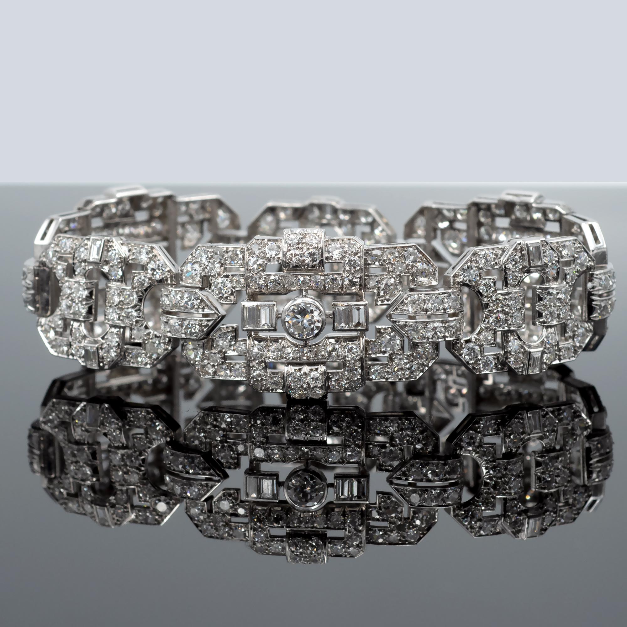 Exquisite diamond bracelet 23 mm wide expertly crafted in solid platinum displaying a stunning geometric open-work Art Deco pattern fully set with diamonds. The three prominent bezel-set, round old European cut diamonds weighing approximately 1.35