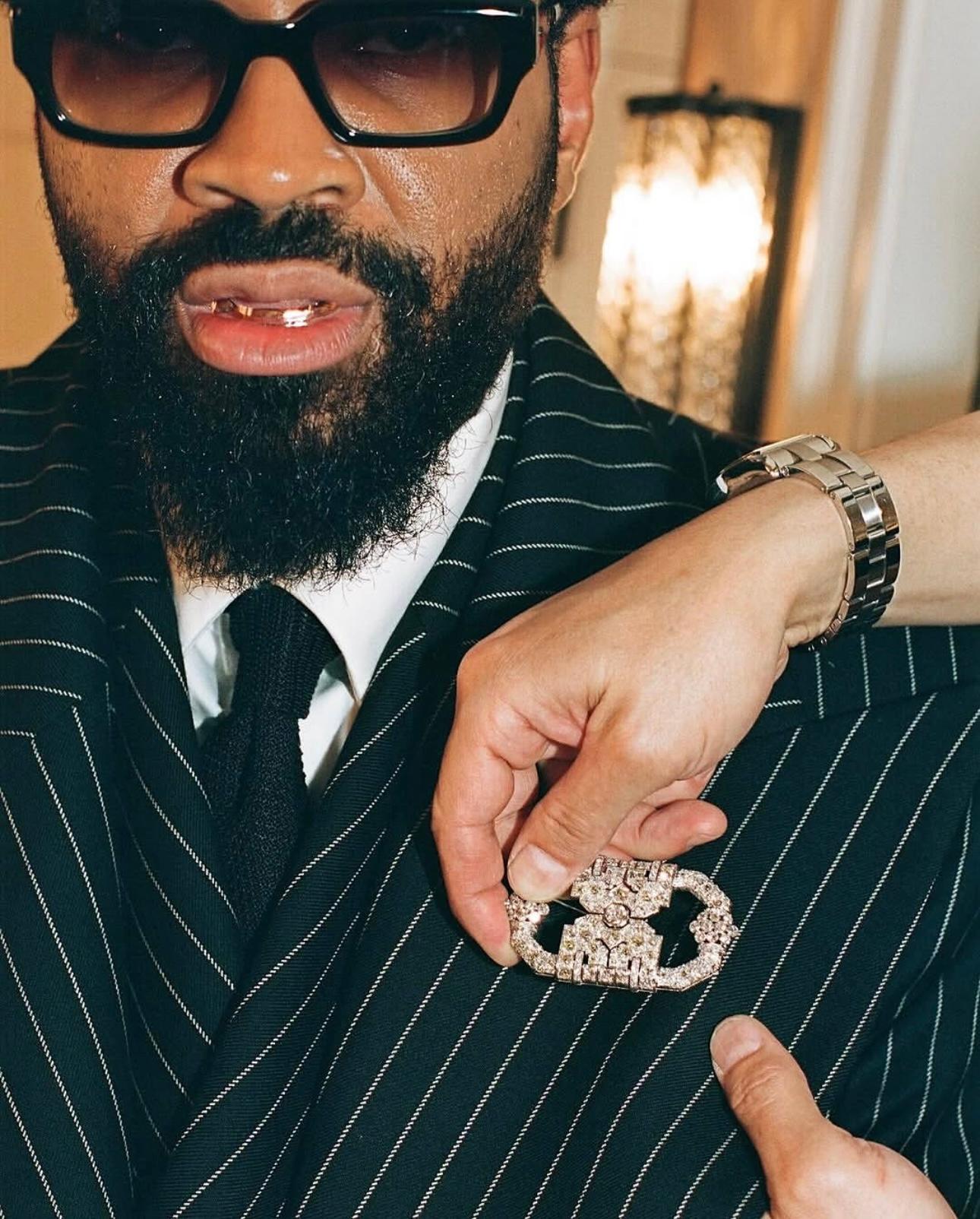 Step into the spotlight with this truly spectacular Art Deco platinum and diamond brooch, a highlight from Maxwell Osborn's ensemble at the 2025 Met Gala. This vintage masterpiece is a testament to the sophisticated design of the period, featuring a