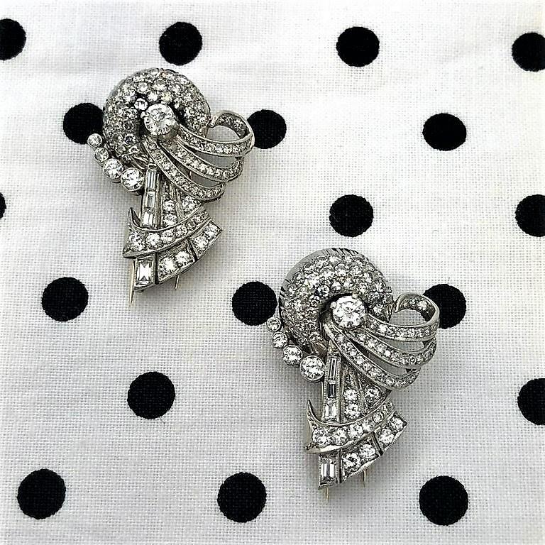 This very beautiful and wonderfully hand crafted pair of Art Deco double clips is diamond encrusted with European cut and Baguette diamonds.  The total approximate diamond weight is 4.75ct of overall G/H color and VS1 clarity. Made to be worn