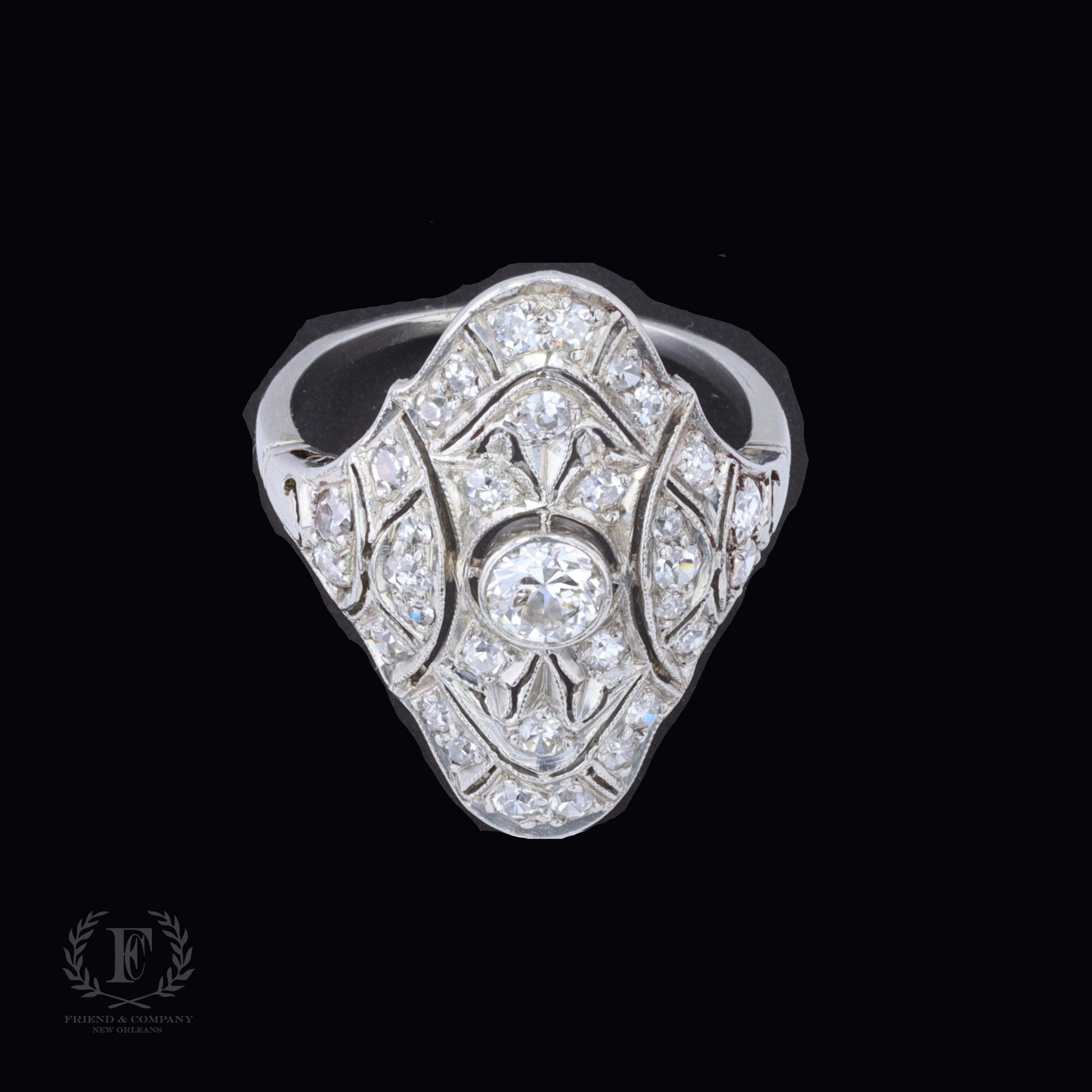 This Art Deco ring is centered with round cut diamonds that weighs approximately 0.45 carats. The color of the diamond is I, and the clarity is SI. The center diamond is accentuated by small round cut diamonds that weigh approximately 0.50 carats.