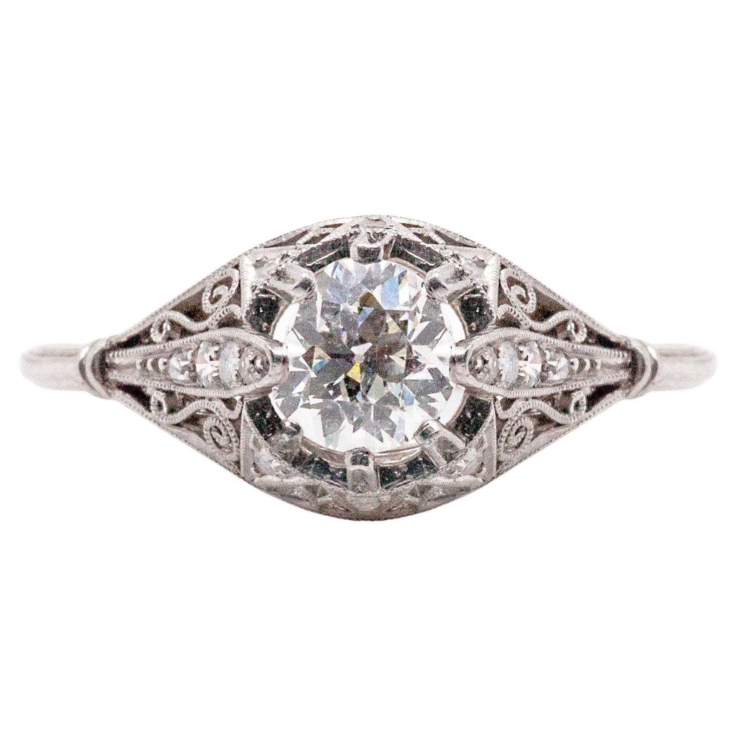 We defy anyone not to fall in love with this breathtaking handmade antique ring. A beautiful Old European Cut diamond weighing an estimated 0.80 carats is set on top of an intricate millgrained filigree gallery, set with an estimated 0.14 carats of