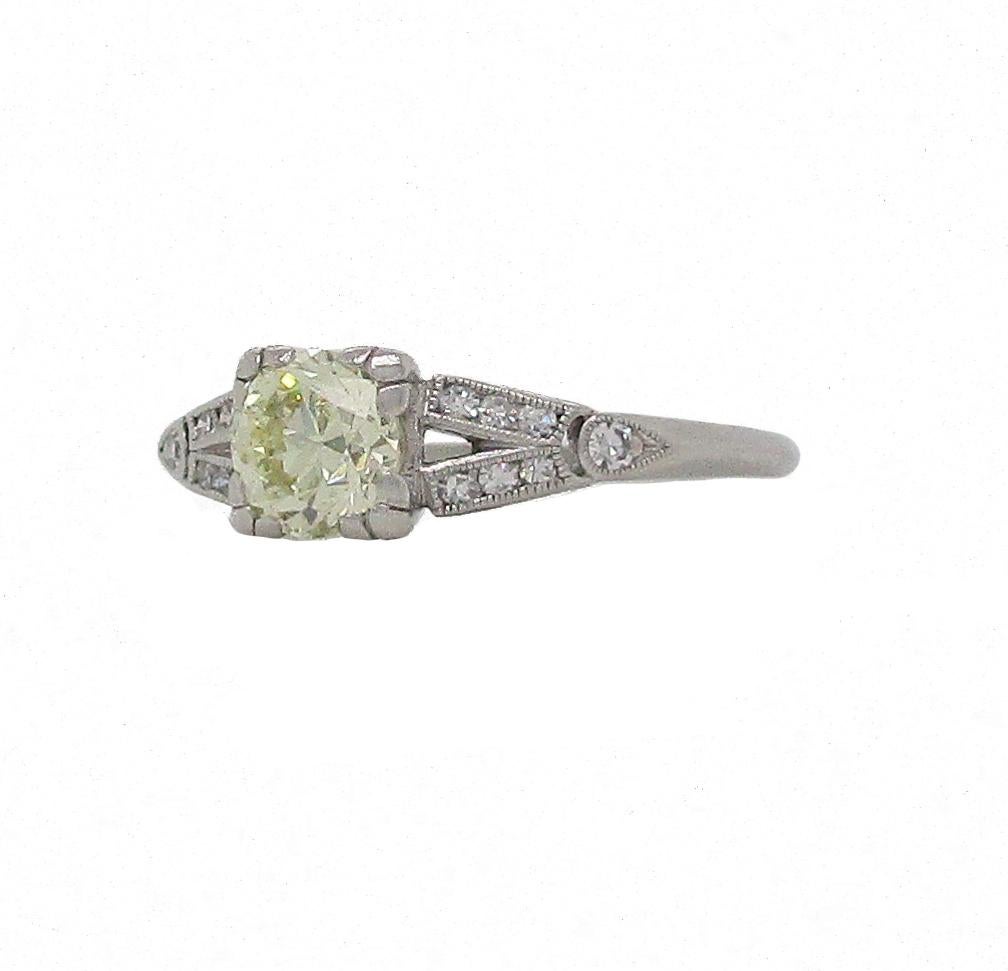 This Art Deco beauty twines together stunning white diamonds with a knockout fancy yellow diamond center stone all on a gorgeous split V platinum setting. This ring boasts the timeless elegance that comes with Art Deco jewelry! The unique setting