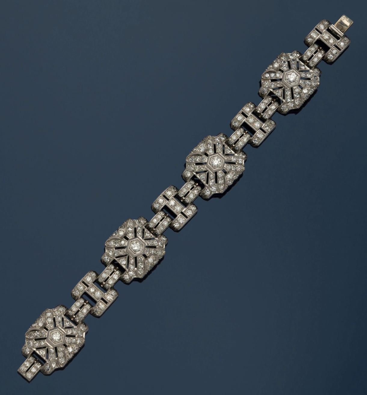 An Art Deco diamond bracelet, circa 1930, of geometric design, set with circular-cut, mounted in platinum, length 17cm
Weight: 32.1g