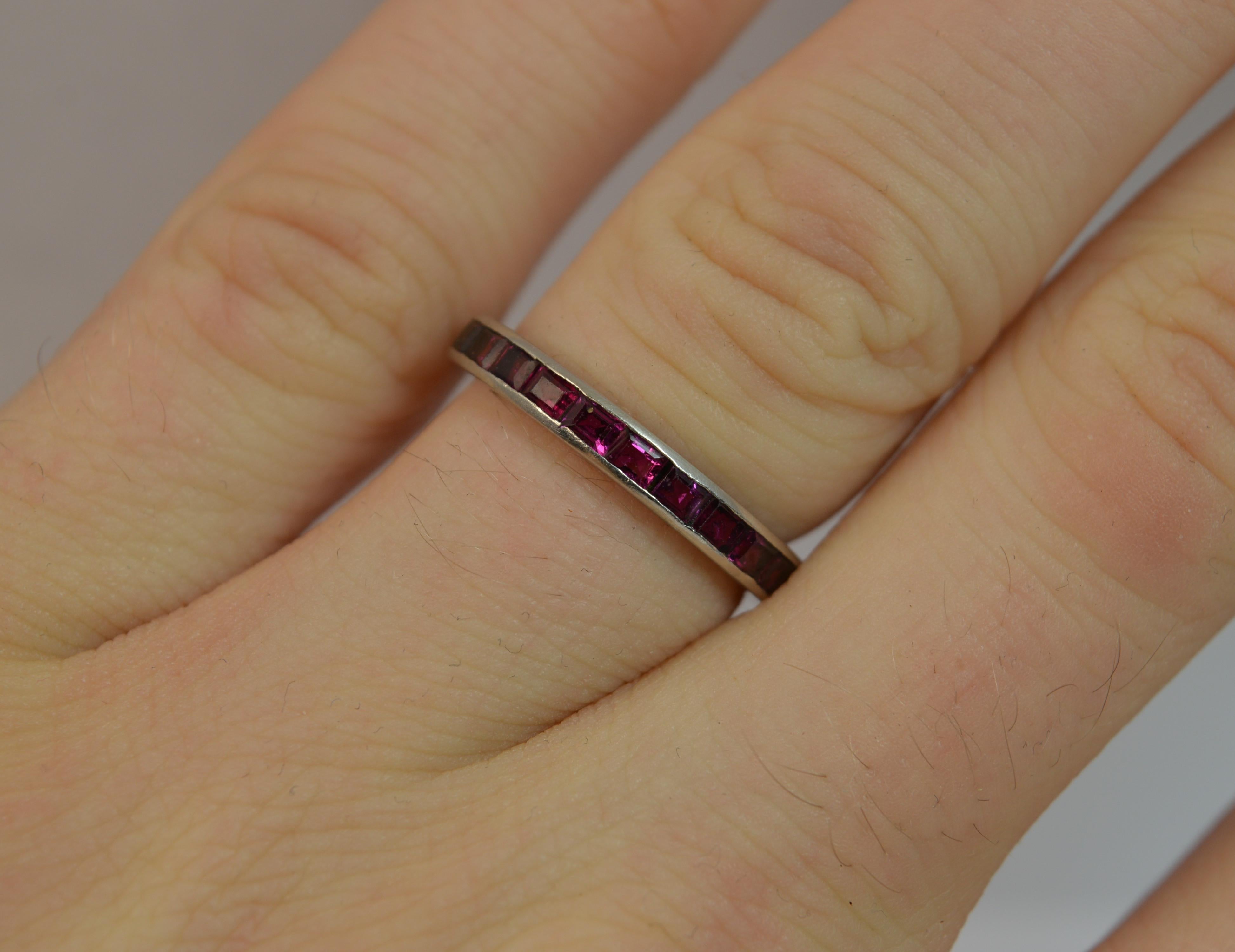 

A stunning ladies full eternity ring. Solid platinum ring. Set with princess cut natural ruby stones. 2.85mm thick band throughout, protruding 2.0mm off the finger. True Art Deco period piece, circa 1910/20's. Plain finish to the band to each