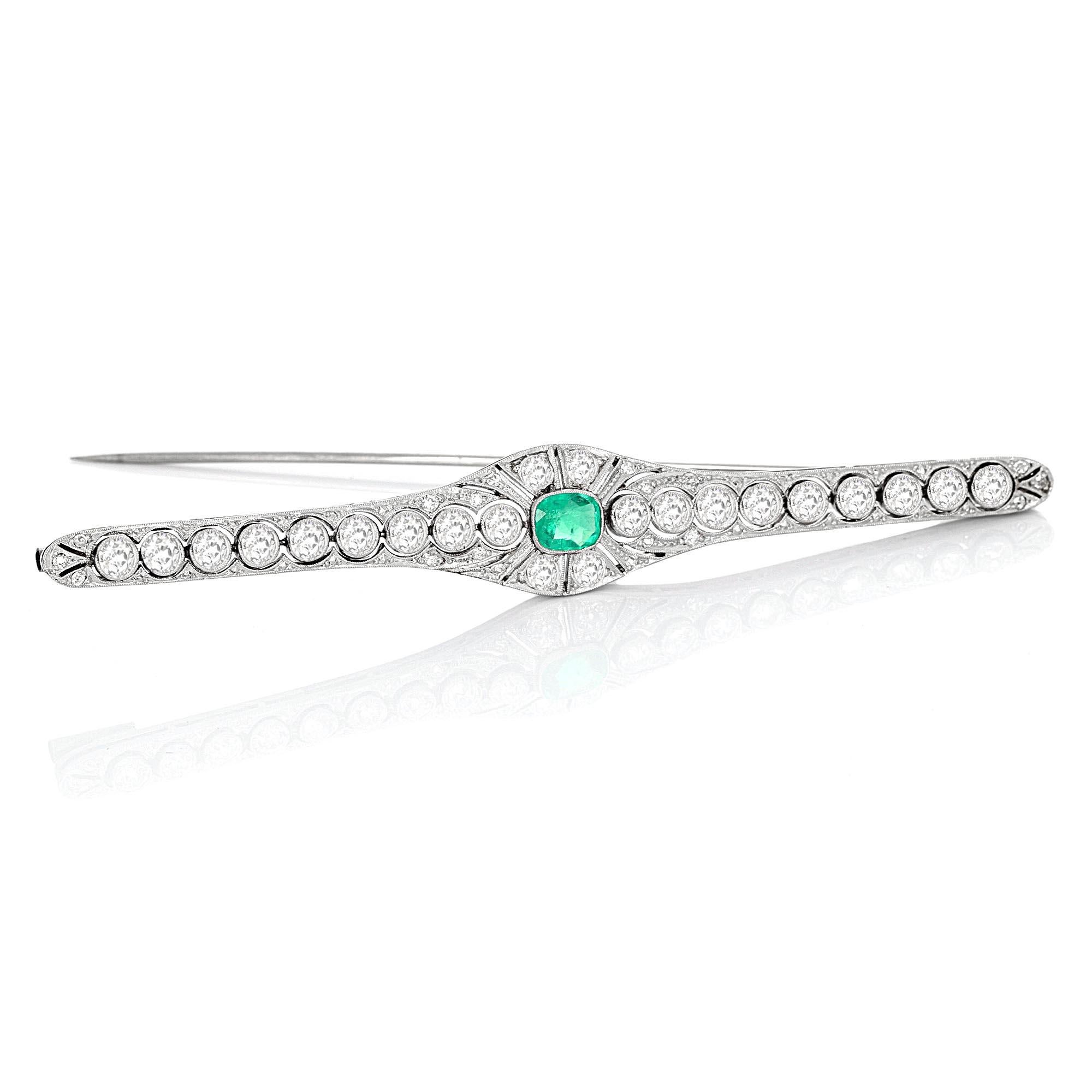 Art-Deco-Brosche aus Platin mit antiken Smaragden und Diamanten. Der Mittelstein ist ein Smaragd im Kissenschliff. Das geschätzte Gesamtgewicht eines weißen, augenreinen Diamanten im alten europäischen Schliff beträgt 4,25 Karat.

Die Brosche misst