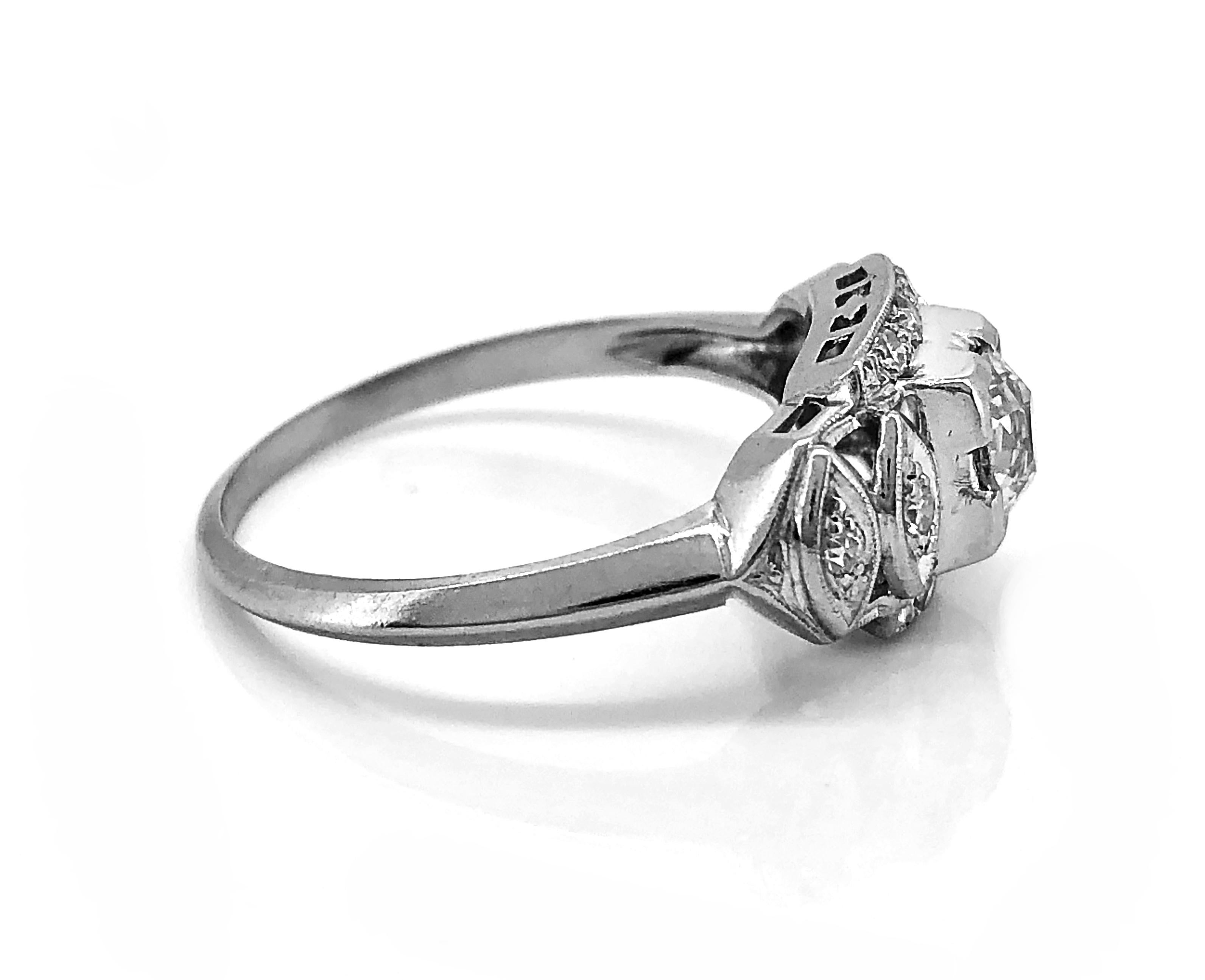 A feminine Art Deco diamond Antique engagement ring that features a .40ct. Apx. European cut diamond with VS1 clarity and H color. The Platinum mounting, which is delicately pierced and milgrained, is accented with .15ct. Apx. T.W. of single cut
