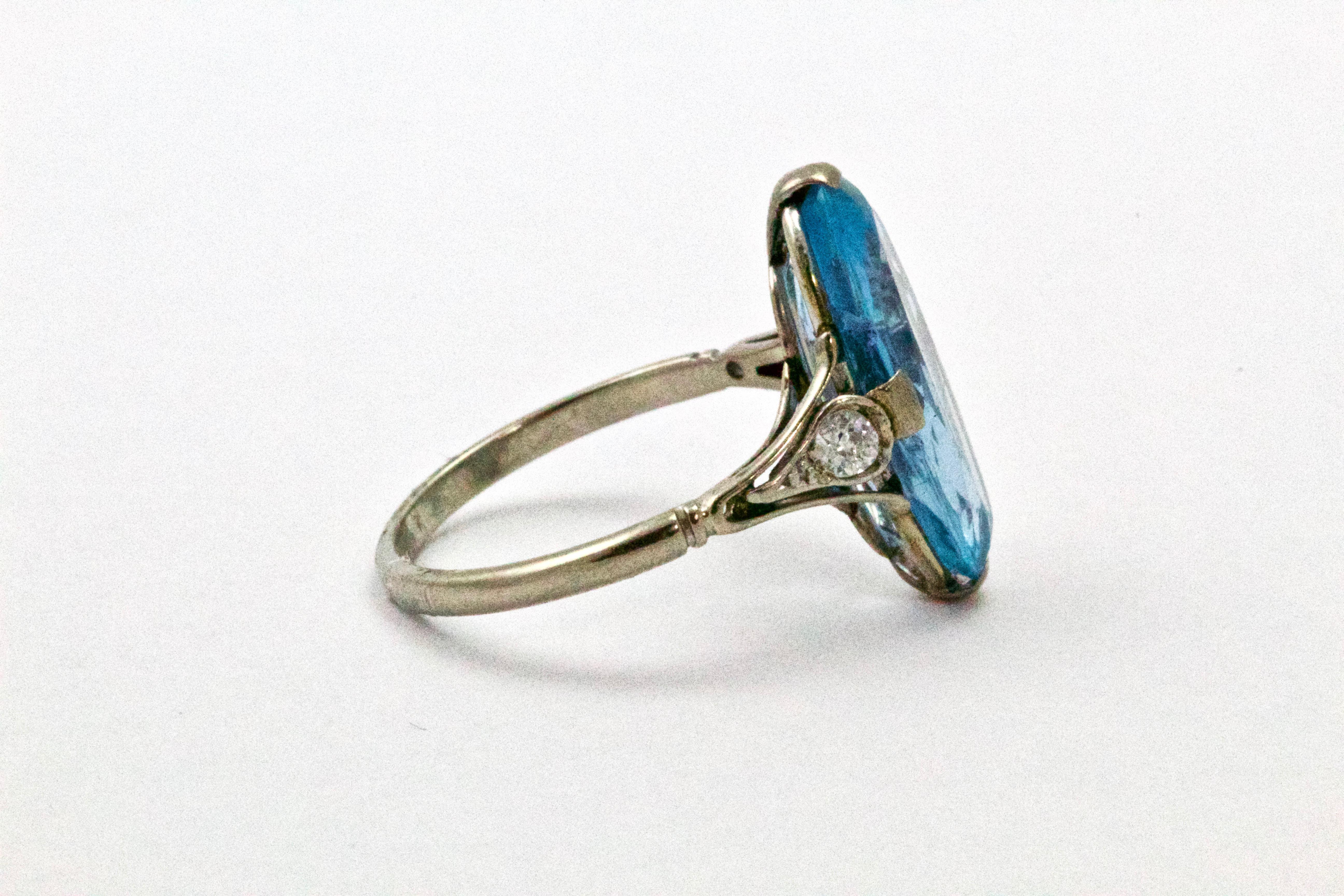 This spectacular Art Deco piece is showcasing a 5 carat oval cut aquamarine flanked my two old European cut diamonds in delicate open-worked shoulders 
Weight: 3.2 grams
Ring Size: M or 6 1/4