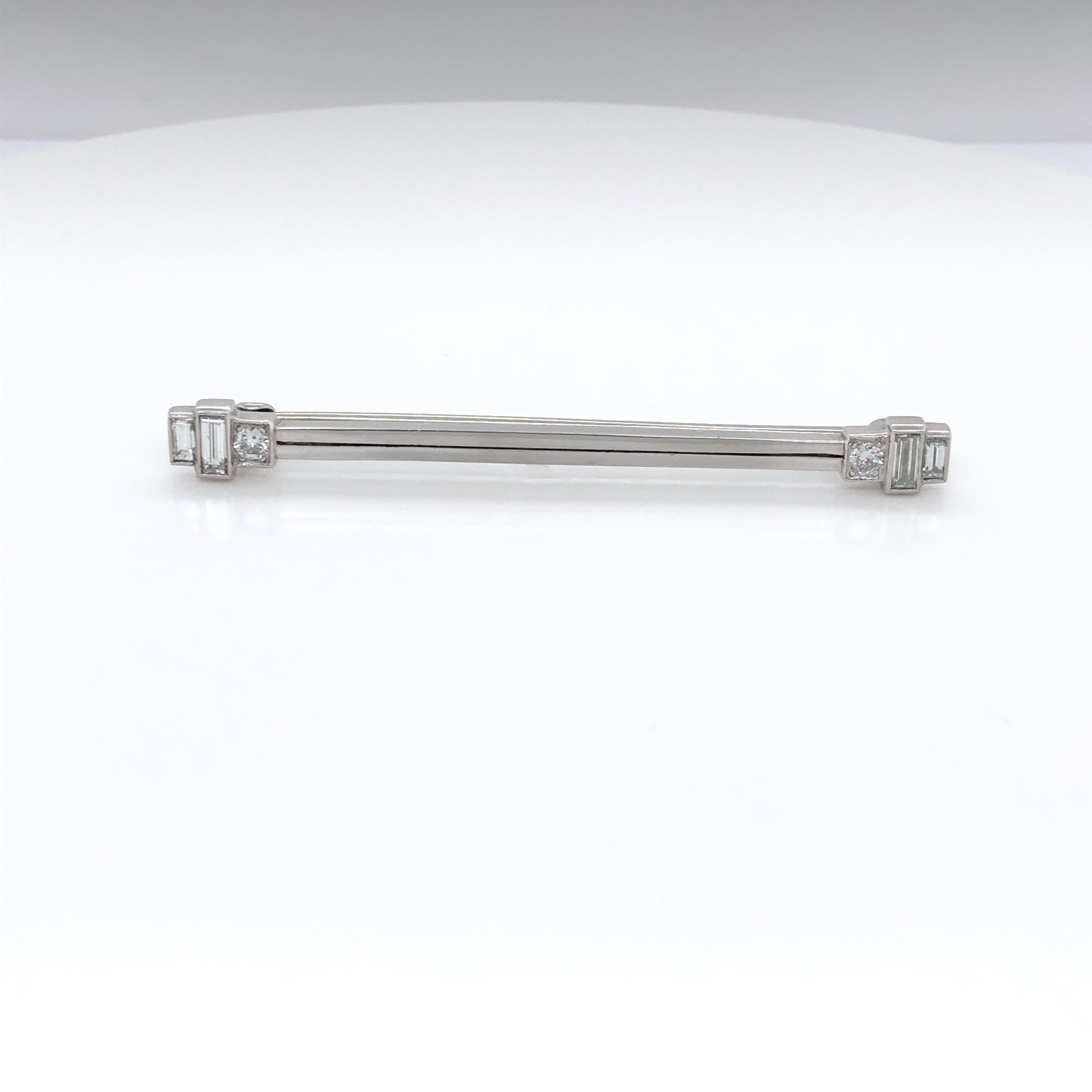 Perk up a breast pocket, scarf or tie with this beautiful art deco platinum and diamond bar pin.  At two inches in length this classic bar pin fits anywhere in your wardrobe. Geometric in shape, each end of the pin is adorned with three diamonds