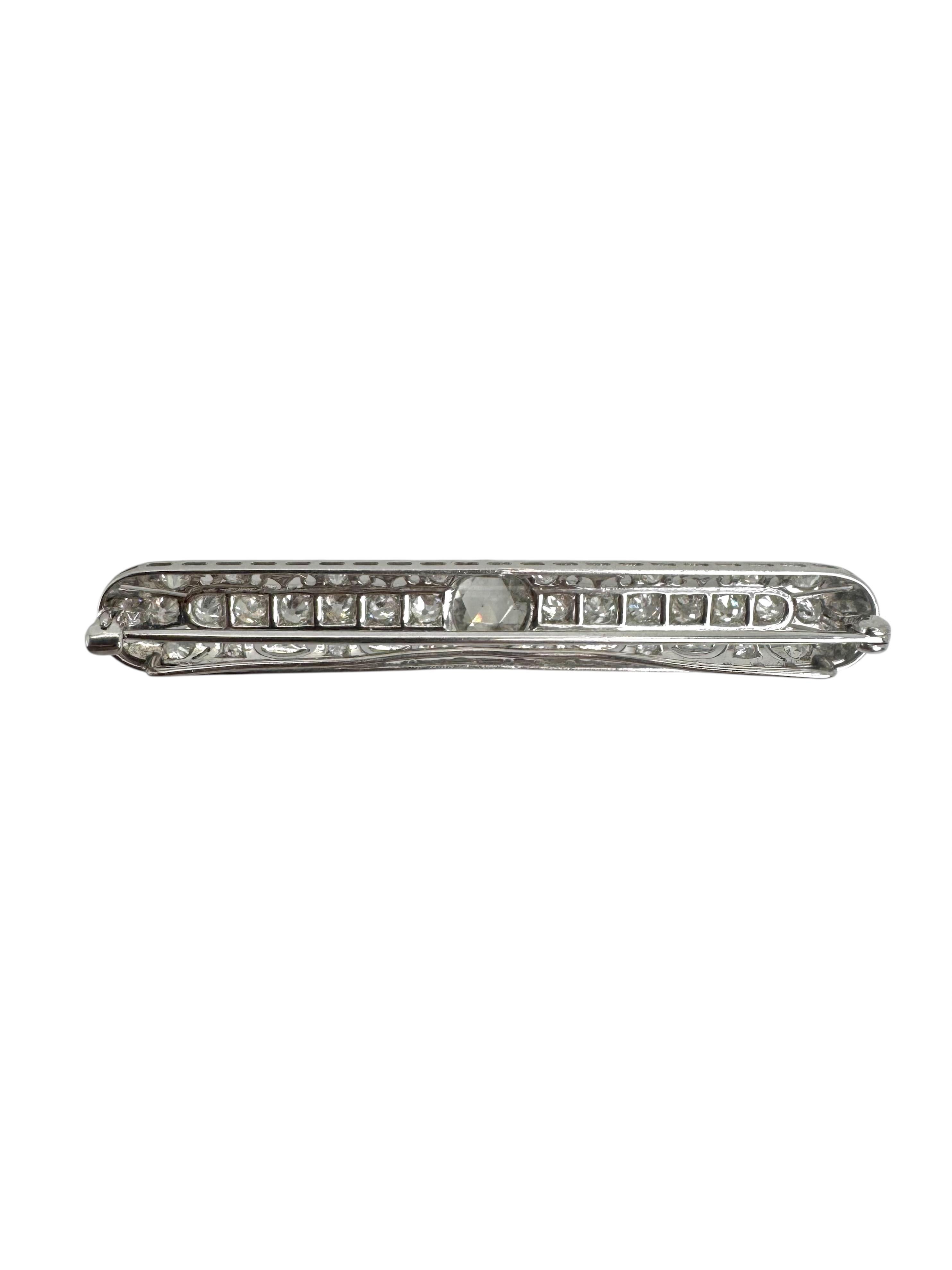 This elegant Art Deco brooch is crafted in platinum and showcases the exquisite geometry and craftsmanship of the 1920s–30s. At its center lies a stunning 0.95-carat rose-cut diamond, bezel-set and framed by a symphony of antique-cut stones. A