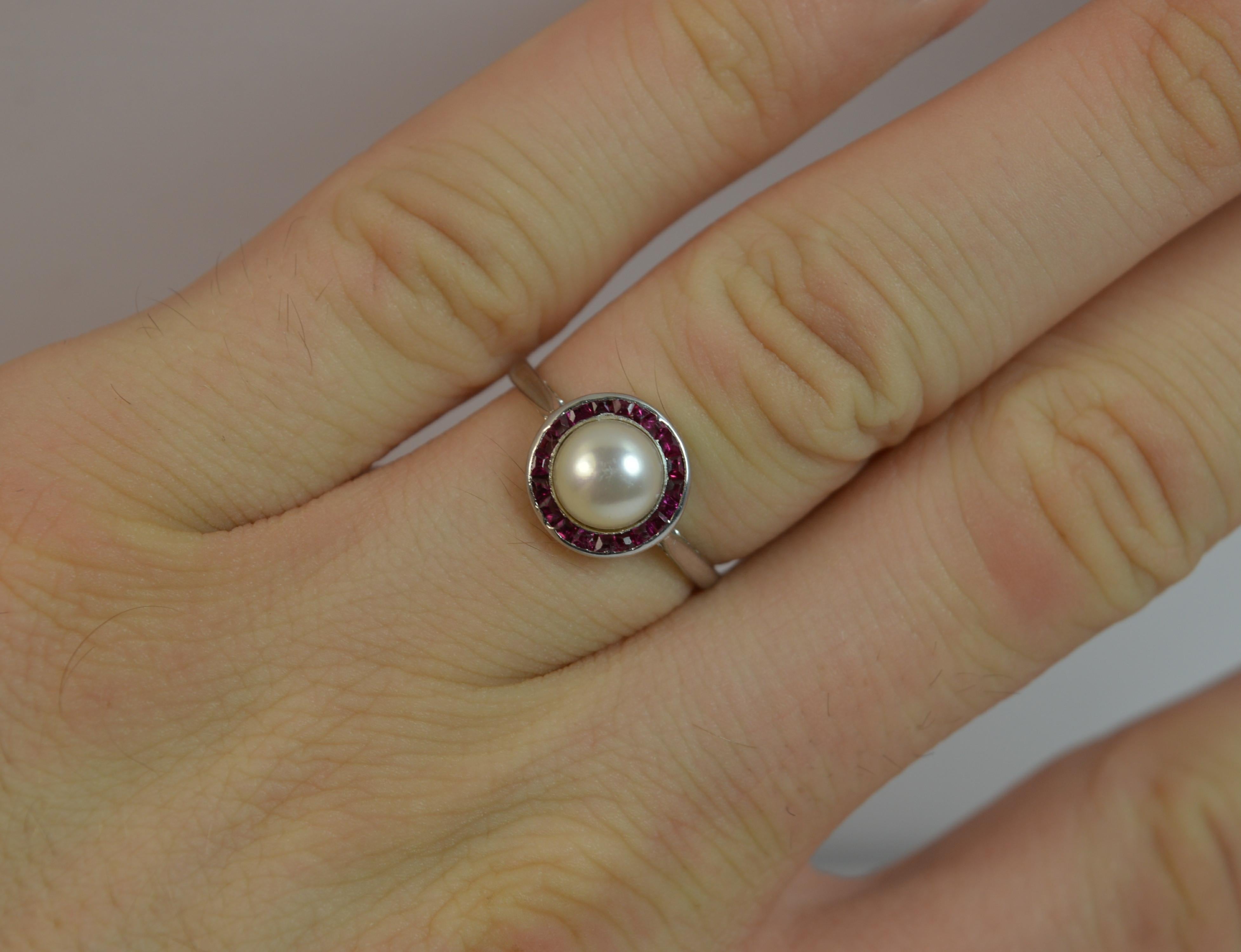 

A stunning ladies Platinum, Ruby and Pearl ring.

​A true art deco period piece, circa 1920/30's.

​Designed with a button pearl to the centre with a full ruby border to form a halo design.

10mm x 10mm cluster approx.


Condition; Excellent.