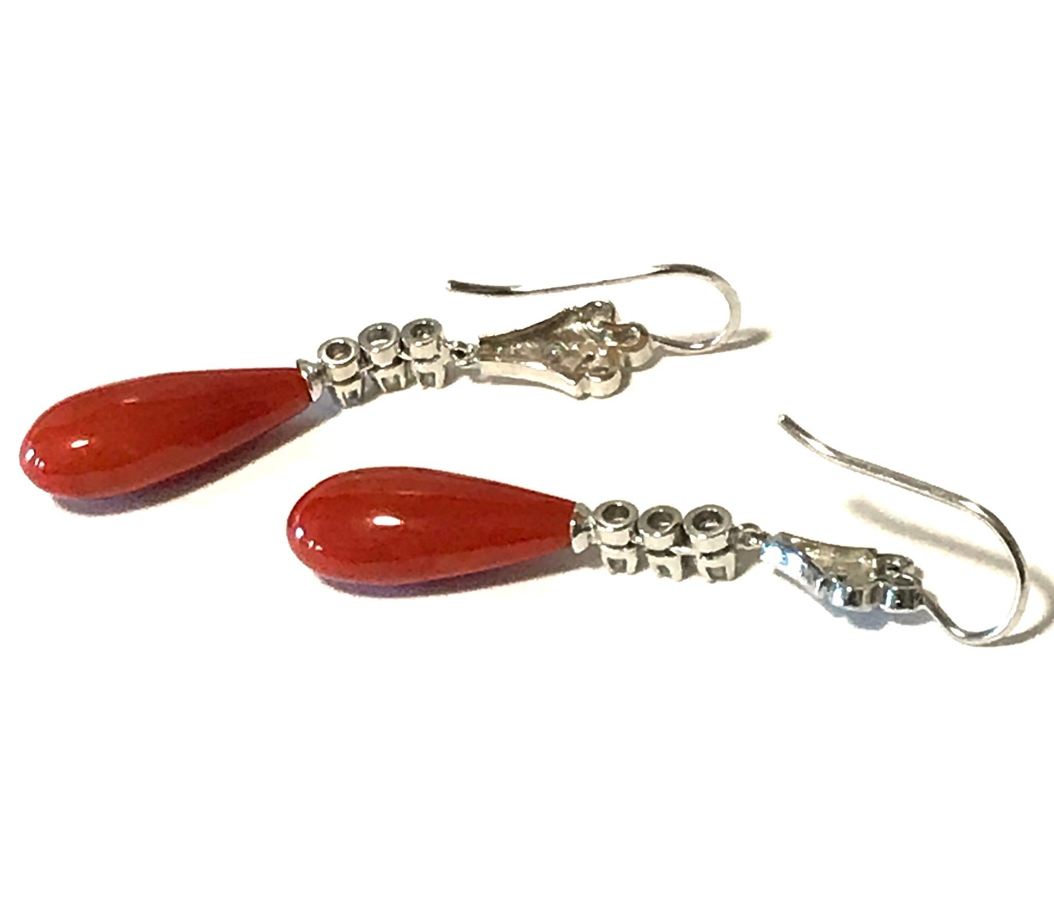 Art Deco coral and diamond drop earrings. Natural corals are of a vivid oxblood color and measure 20mm long x 7mm and 8mm wide. Mixed cut diamonds weigh .50 dtw. and are set in platinum.
In great antique condition with age-appropriate wear and use.