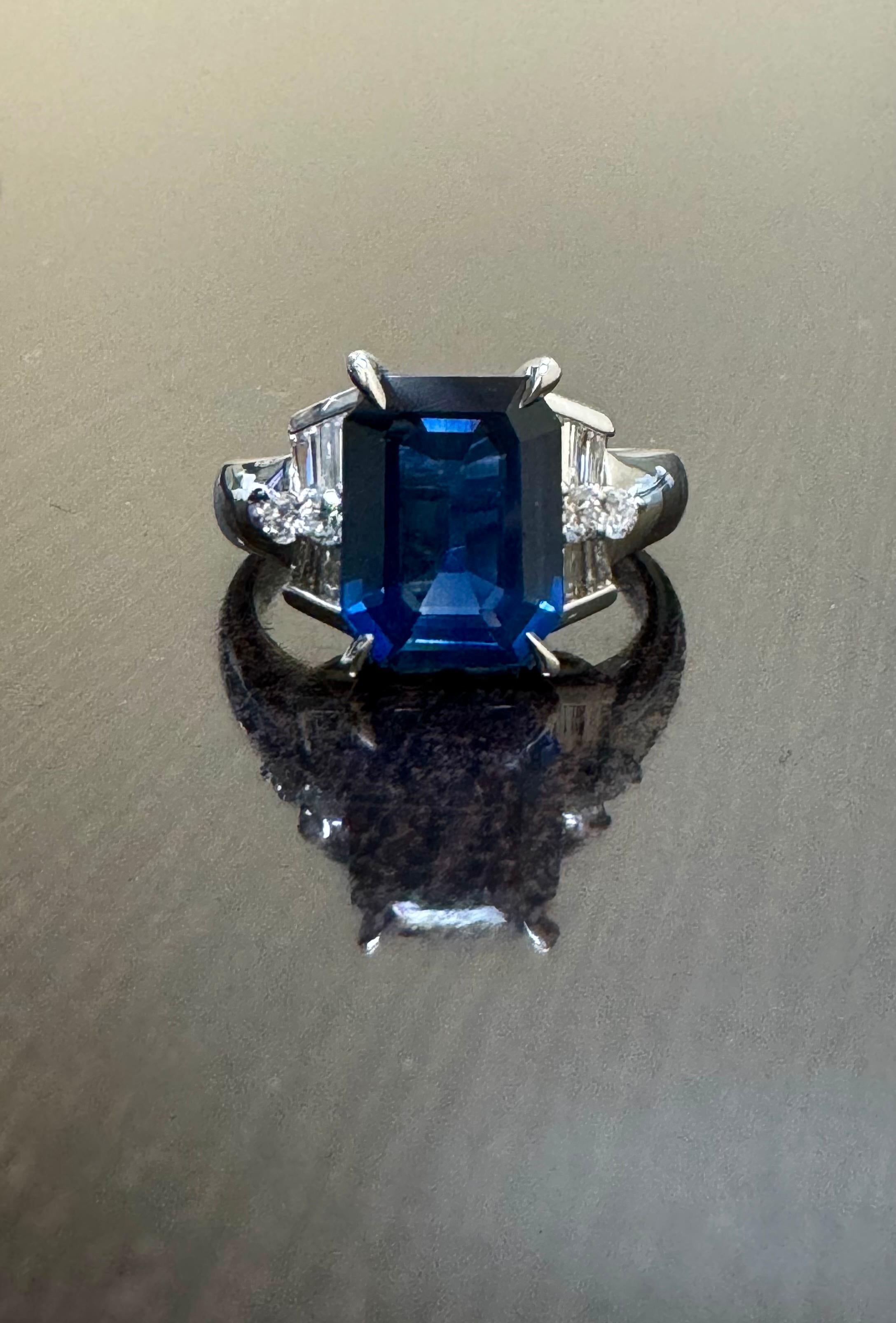 DeKara Design Collection

Metal- 90% Platinum, 10% Iridium.  

Stones- 1 Genuine Emerald Cut Blue Sapphire 4.26 Carats, 4 Baguette Diamonds F-G Color VS2 Clarity, 4 Round Diamonds F-G Color VS2-SI1 Clarity, 0.59 Carats. 

Size- 7 3/4.  FREE