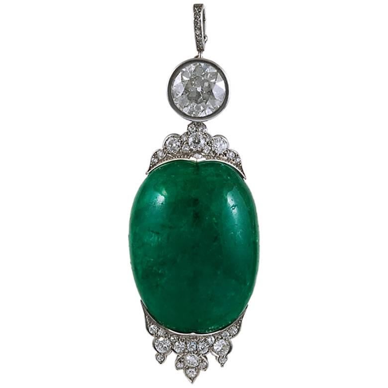 A superb sautoir necklace from the 1920s comprised of several cabochon emeralds placed within five rows of round-cut diamonds, with a suspending large cabochon and diamond pendant at the center, finely crafted in platinum. 

cabochon emerald –