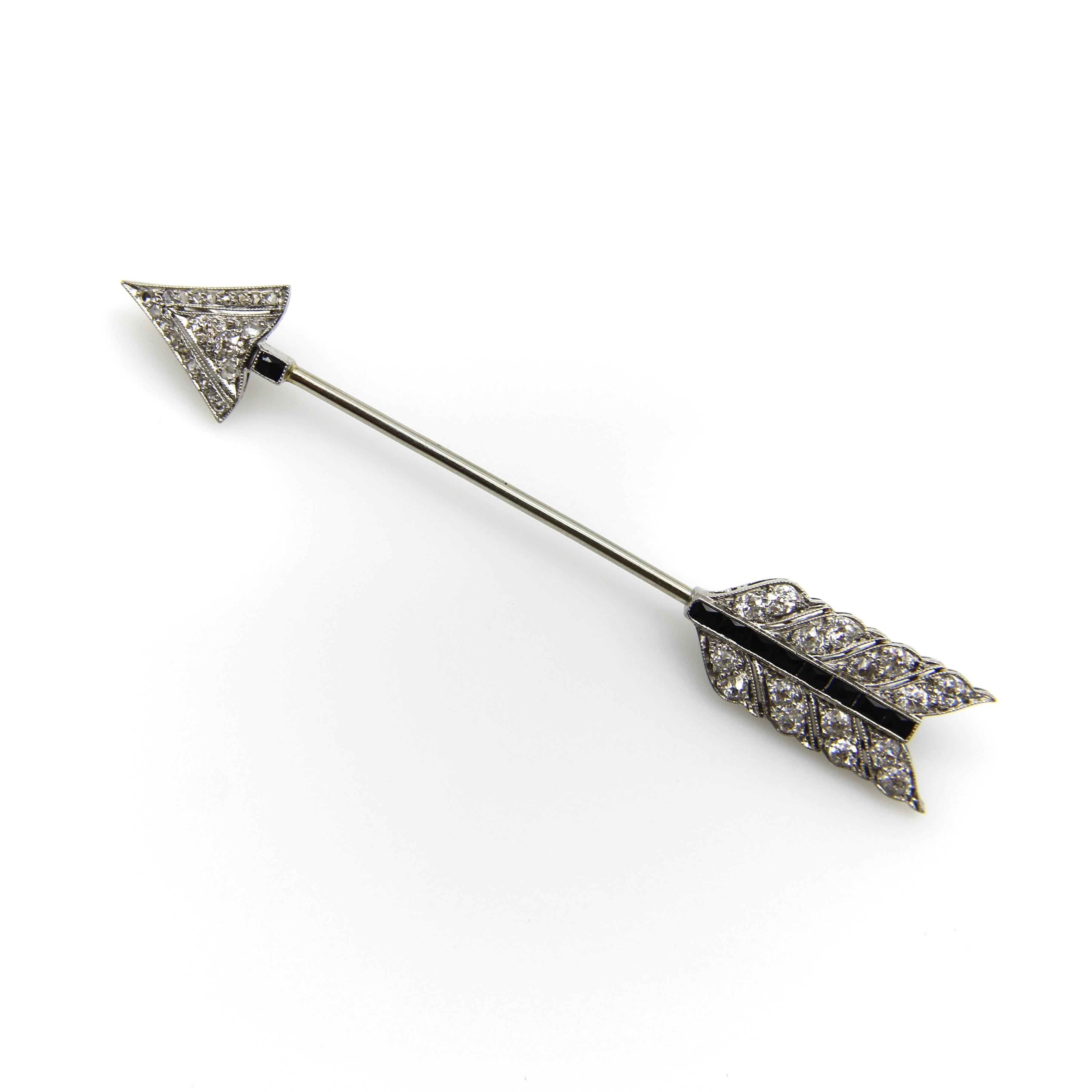 We’ve made this Art Deco platinum jabot pin multifunctional by adding two bails so that it can be worn on a chain as well as its original function as a Jabot. The pendant is encrusted with diamonds and onyx. The point of the arrow contains tiny Rose