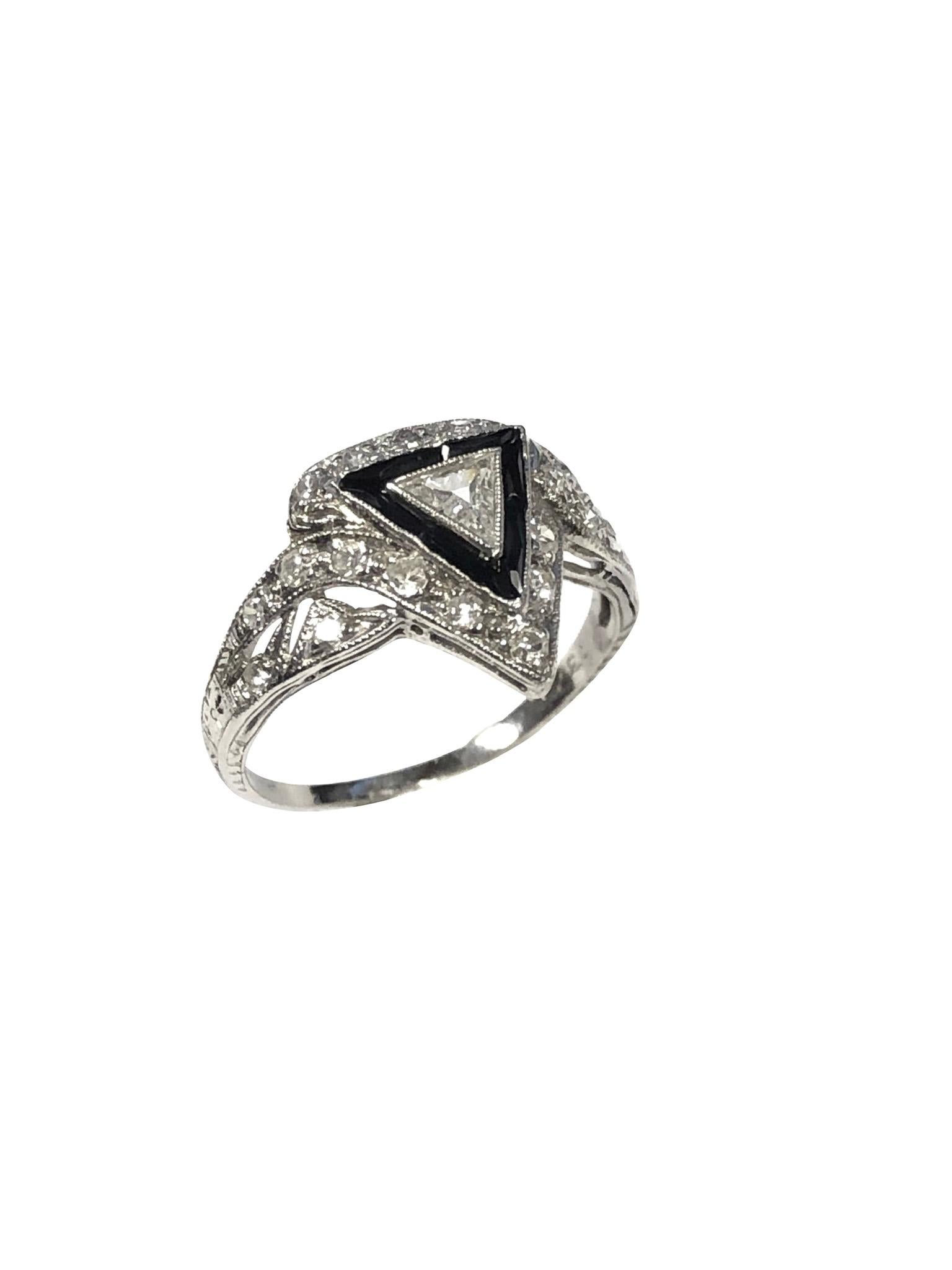 Circa 1930 Platinum Ring having Good strong Art Deco styling, centrally set with a Triangular cut Diamond approximately 1/2 Carat, surrounded by Rectangular faceted Onyx and further set with smaller old cut Diamonds. The top of the ring measures 1/2