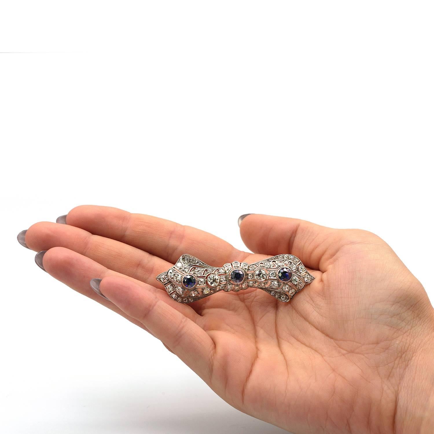 Art Deco Platinum  Brooch has approximately 2 1/2 carats of beautiful old mine cut diamonds with 3 round sapphires weighing approximately 1 1/2 carats. 