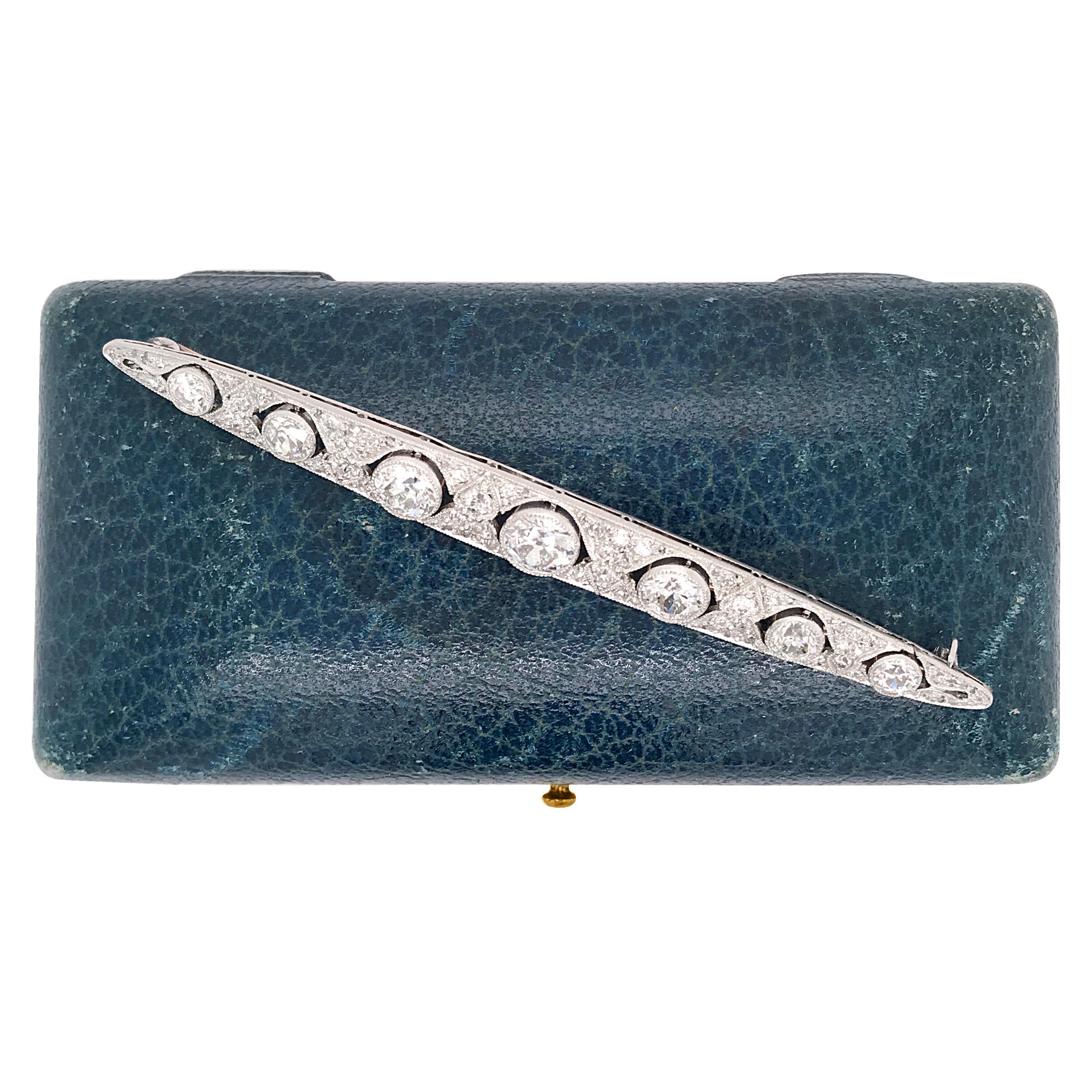 This antique Art Deco diamond bar brooch is crafted in solid platinum. Center with a round diamond approx. 1.2cts graded I color and VS clarity and mounted within an exquisite filigree setting with heart shape profiles. The eye-catching center stone