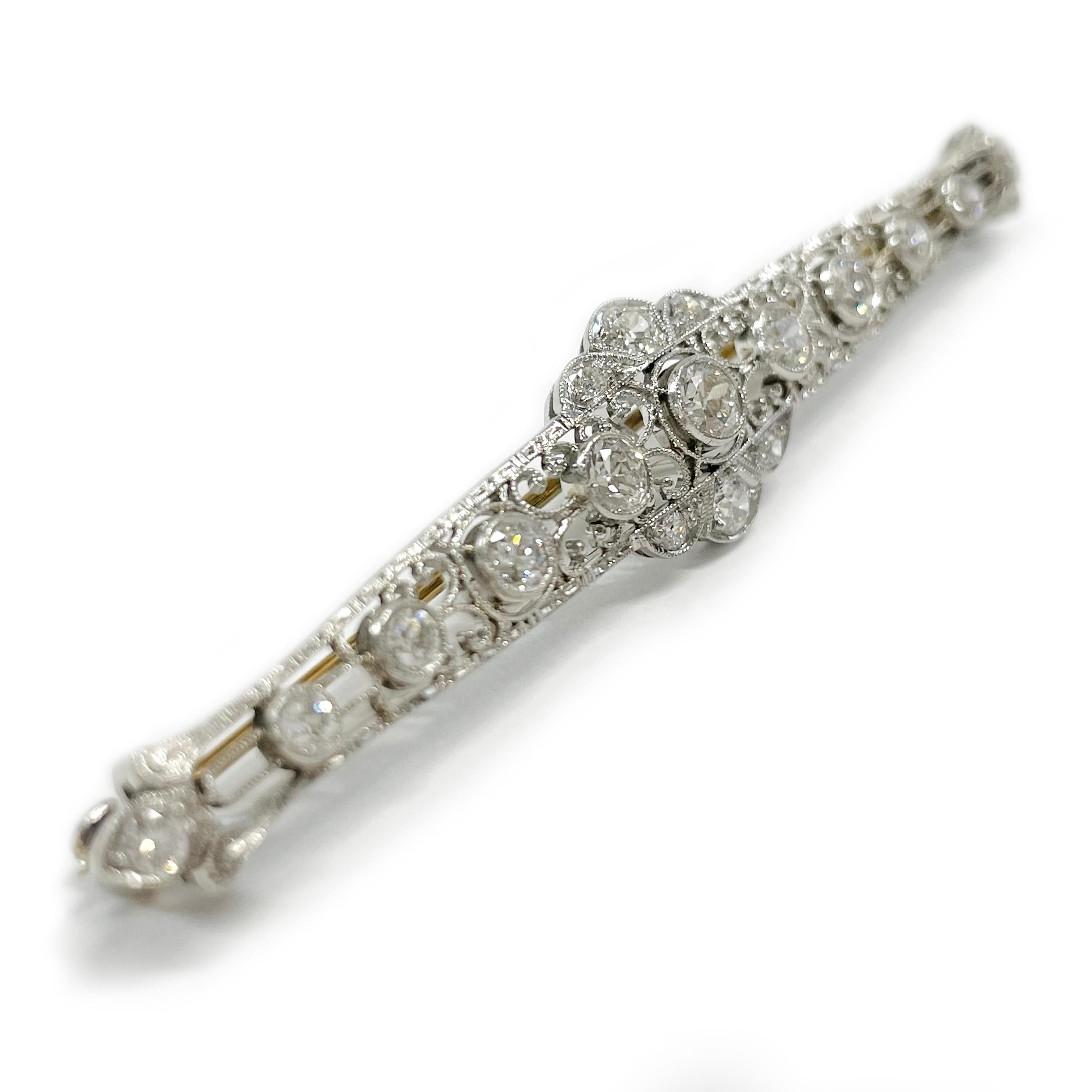 Art Deco Platinum Diamond Bar Brooch/Pin. This absolutely gorgeous pin features seventeen round diamonds, nine graduate diamonds are bezel set across the center and eight are bead set. This lovely piece offers intricate milgrain detail. There is one