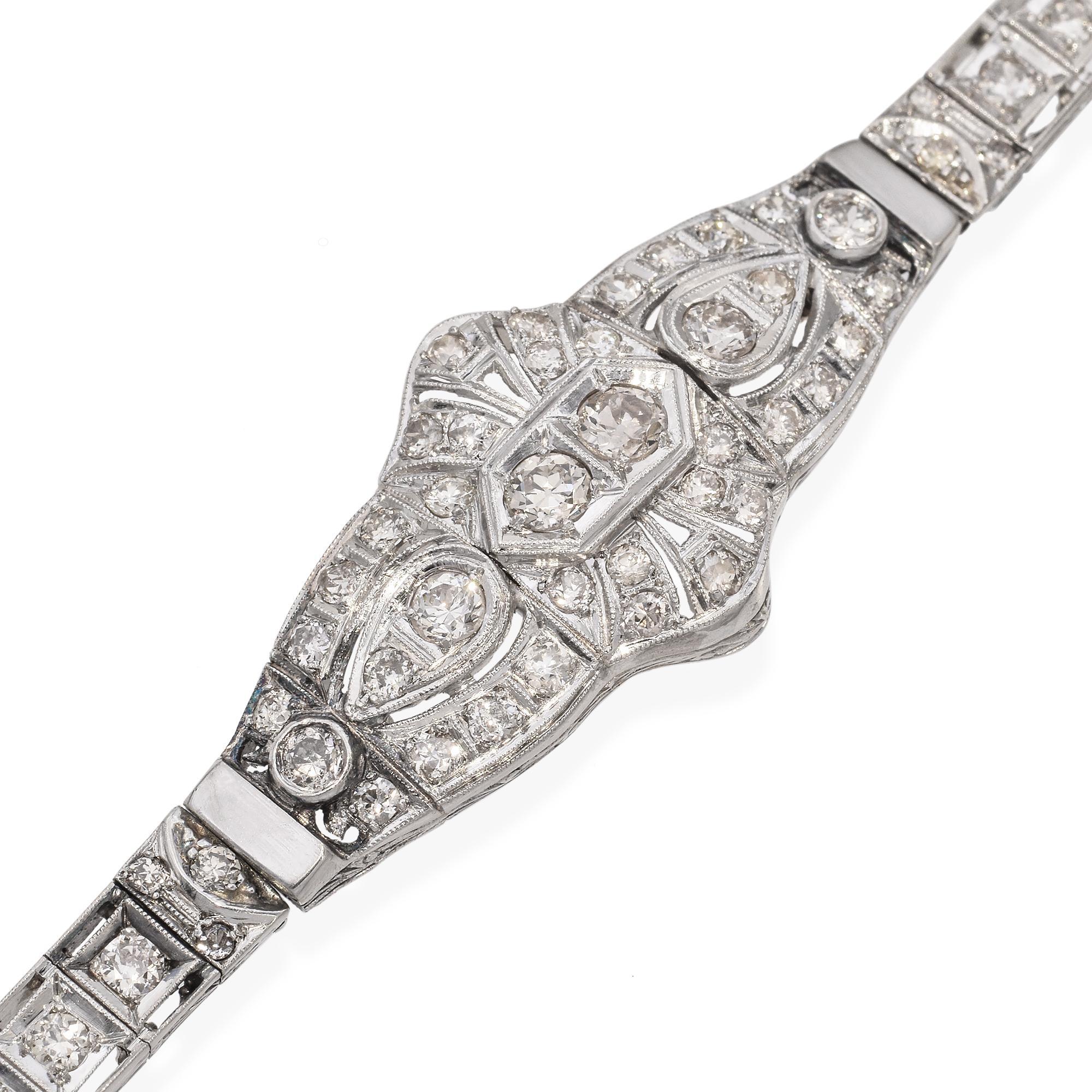 This art deco platinum diamond bracelet is a breathtaking example of early 20th-century elegance and craftsmanship. Expertly handcrafted in luxurious platinum, the bracelet features a delicate, lacy design adorned with old European that shimmer with