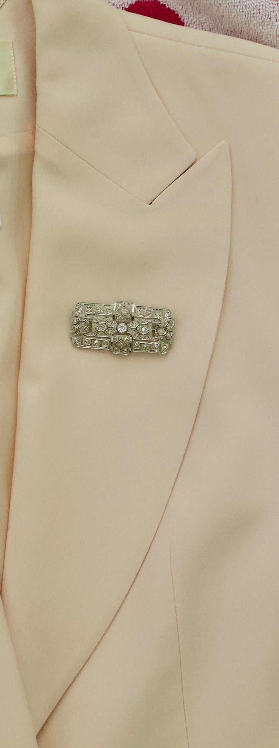 Art Deco Platinum Diamond Brooch Circa 1930's
Purchased From a Renowned Hollywood and Broadway Actors Family
One Round Brilliant Cut Diamond weighing .35 carats approximately  [GHI-SI]
Forty Six Round Brilliant Cut Diamonds weighing 1.65 carats
