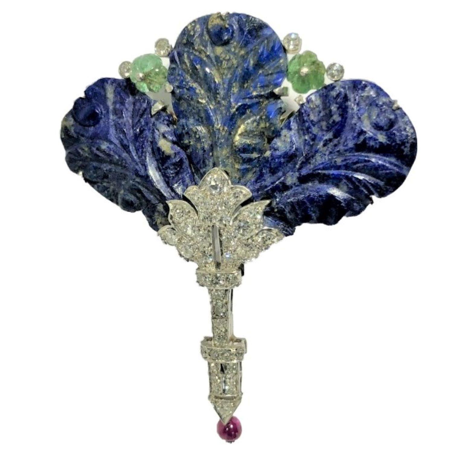 This exquisite and highly stylized platinum floral creation incorporates three carved lapis lazuli panels, two fluted emerald beads, a single ruby bead and diamonds, all set in a handmade frame crafted specifically for this masterwork. The