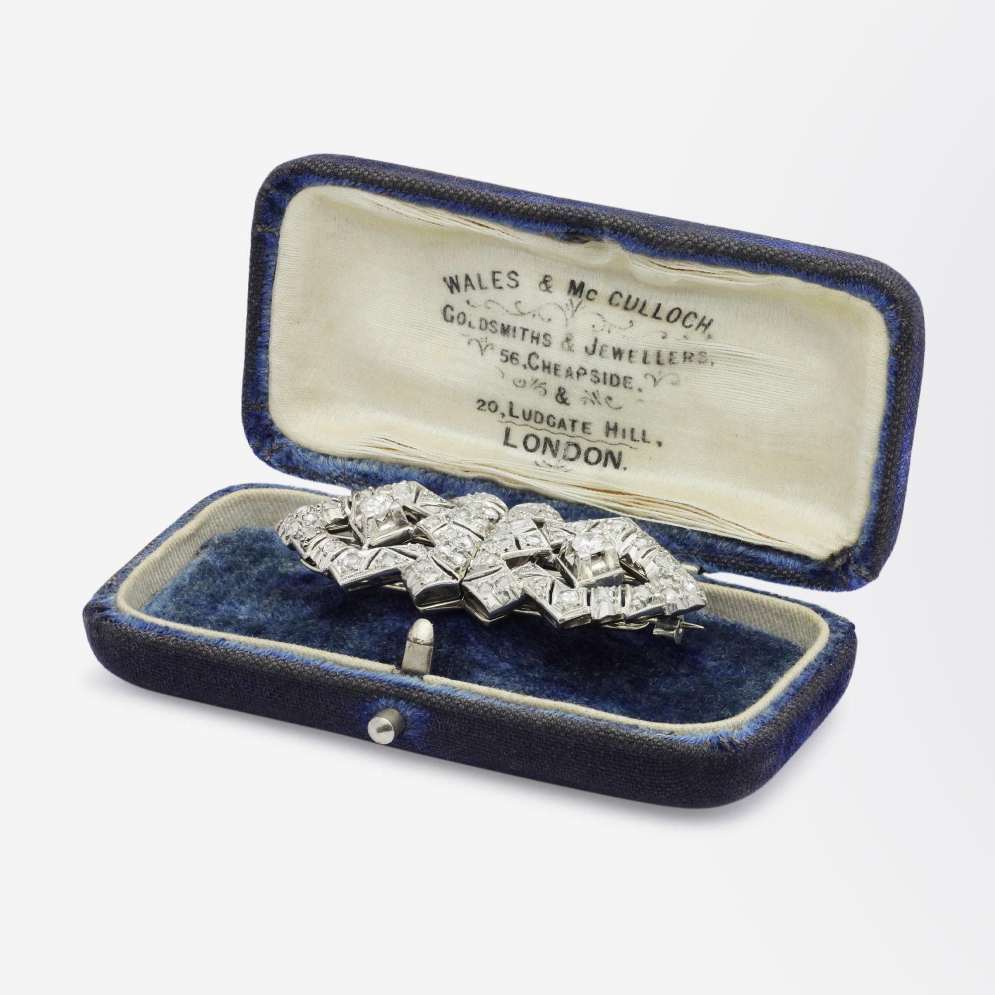A beautiful Art Deco period platinum and diamond brooch by Argentinian maker, Walser Wald. The handmade platinum brooch separates off the frame it is presented on and becomes two identical dress pins, sometimes known as 'collar clips'. The two clips