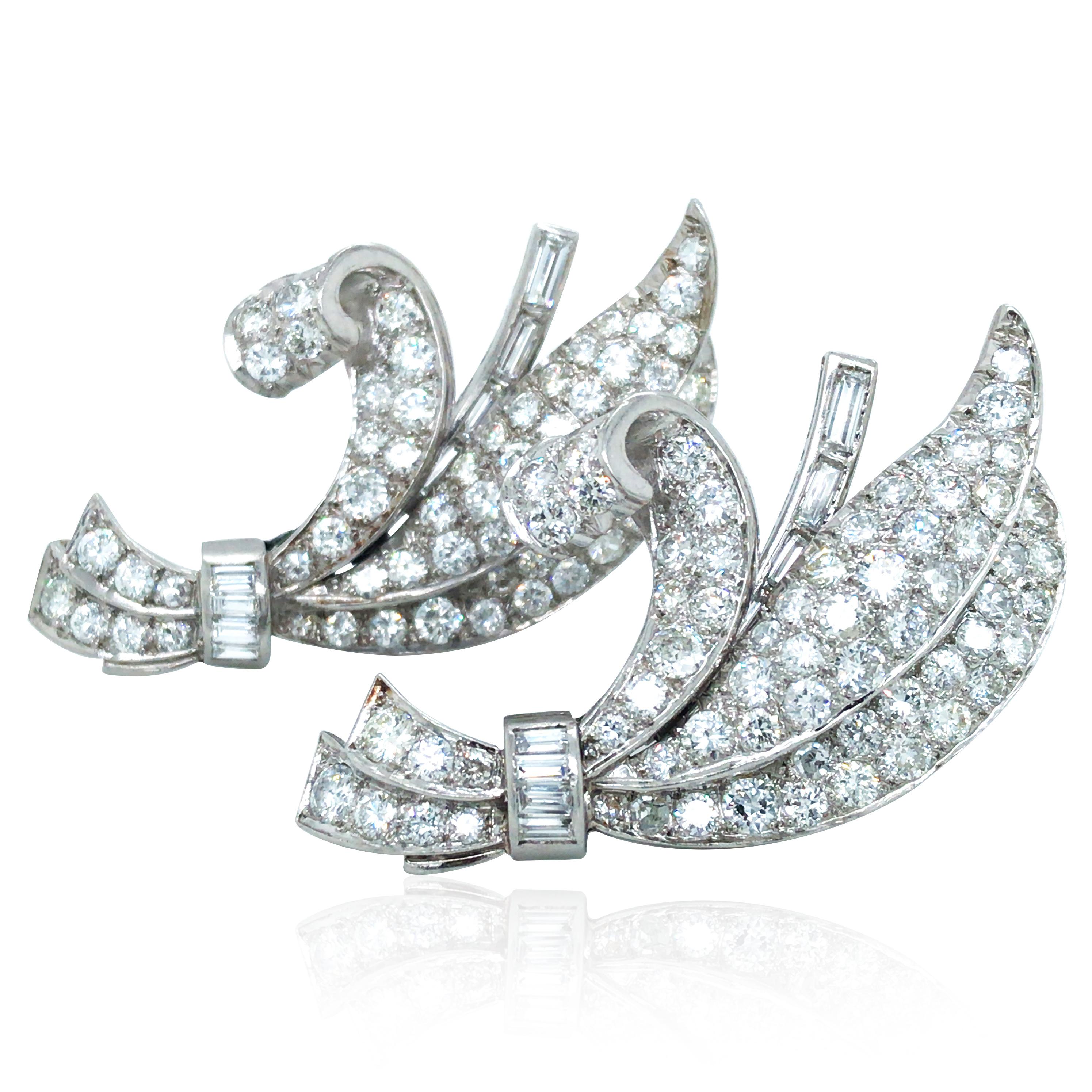 These diamond double pin brooches are crafted in platinum. They consist of 16 baguette-cut and 130 round-cut diamonds approx. 8ct in total.

Diamond: 8ct
Weight: 27.1grams
Measurement: 4.7x2.8cm