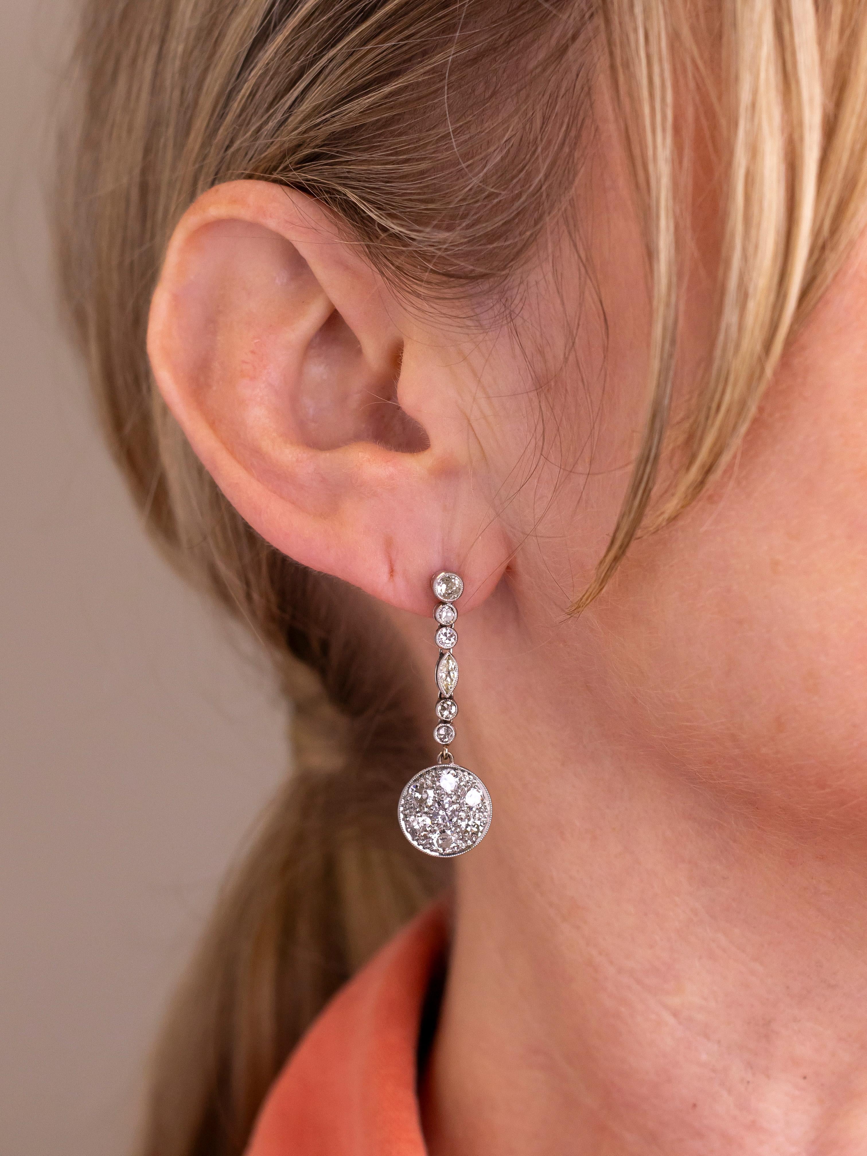 This rather delightful pair of platinum and diamond earrings date to the Art Deco period and have been made by hand. The stud type earrings have a platinum thread and screw back, meaning when they are on the ear they are extremely secure. The top of