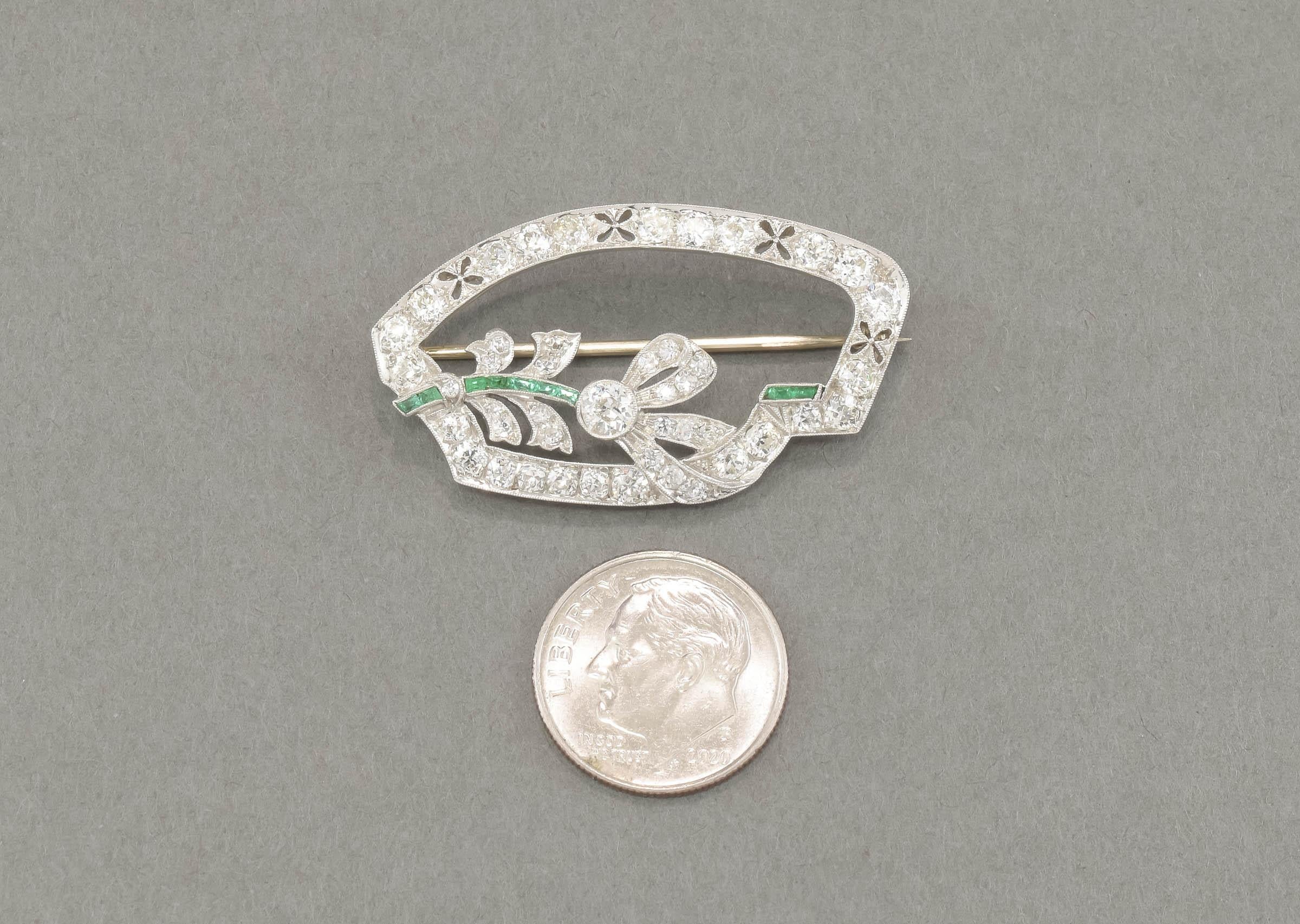 So elegant, this incredibly fiery old cut diamond and emerald brooch dates to the late 20’s to 1930’s Art Deco period  Fabulous as a brooch, it would also be wonderful converted into a necklace.

Crafted of platinum with a 14K white gold pin stem &