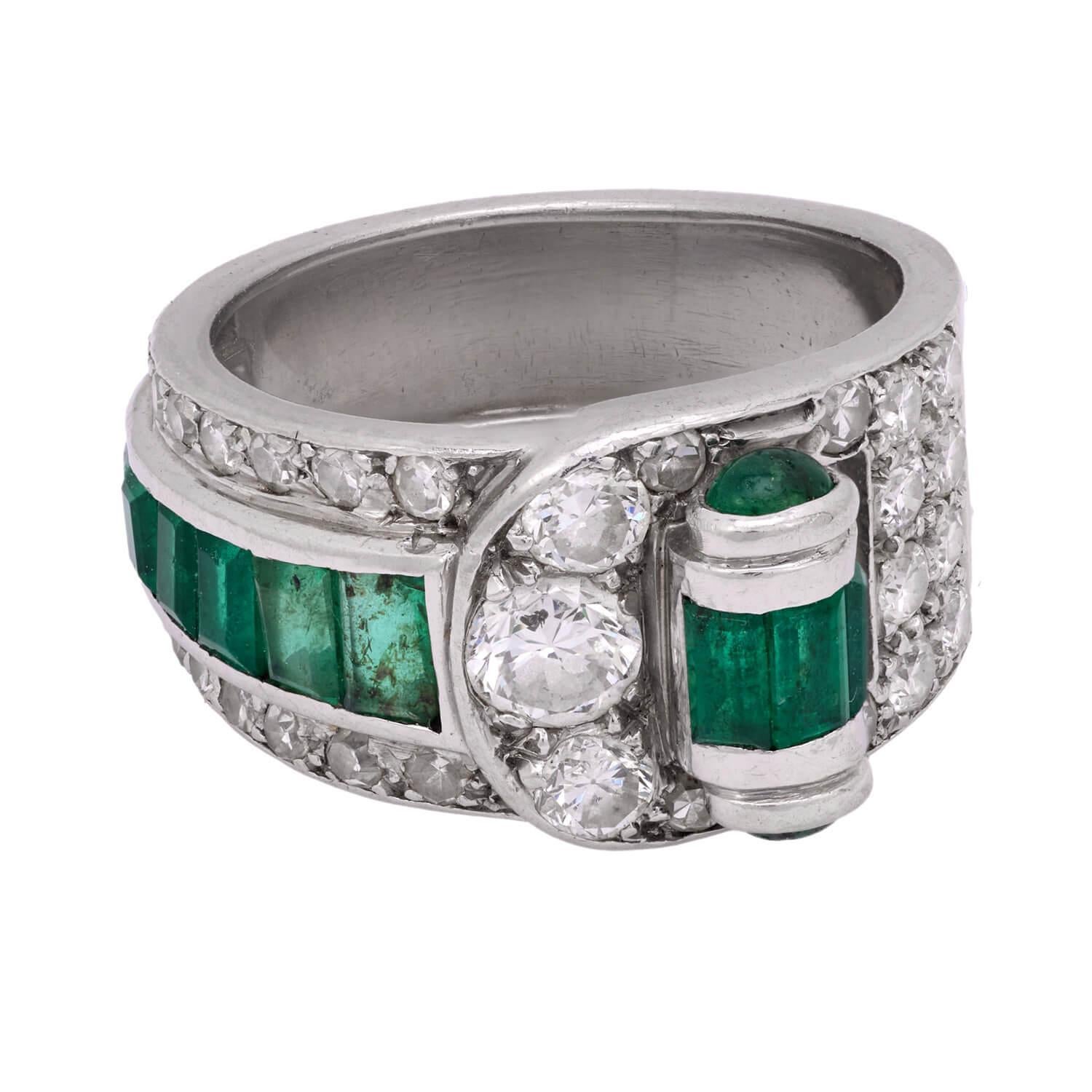 A fabulous diamond and emerald ring from the Art Deco (ca1920s) era! Crafted in platinum, the ring features unique buckle-like design. The front of the ring is encrusted with 1.75ctw of bead-set old European cut diamonds. The front of the ring also