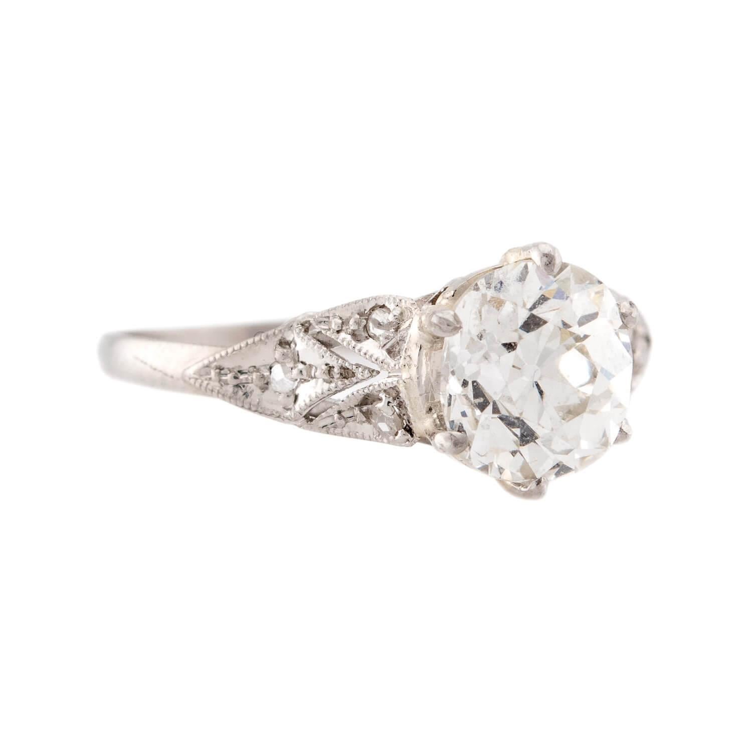 An absolutely stunning diamond engagement ring from the Art Deco (ca1920s) era! Crafted in platinum, this gorgeous ring features a 1.55ct old mine cut diamond. The stone is held within a six-prong setting, and displays I/J color and SI1 clarity. The