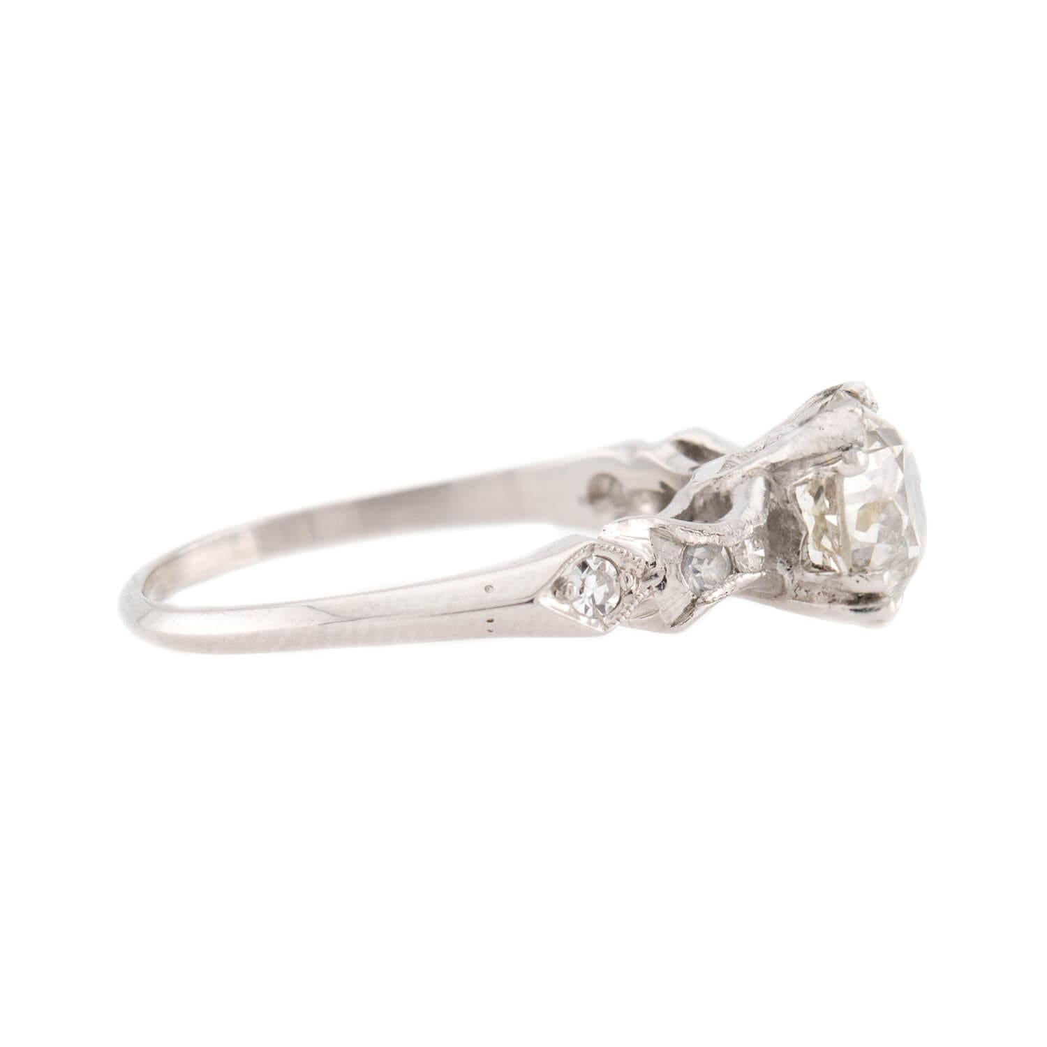 A breathtaking diamond engagement ring from the Art Deco (ca1920s) era! Crafted in platinum, this ring features a central 1.57ct old mine cut diamond, which rests within a three-clawed four-prong setting. The stone displays K/L color and SI1