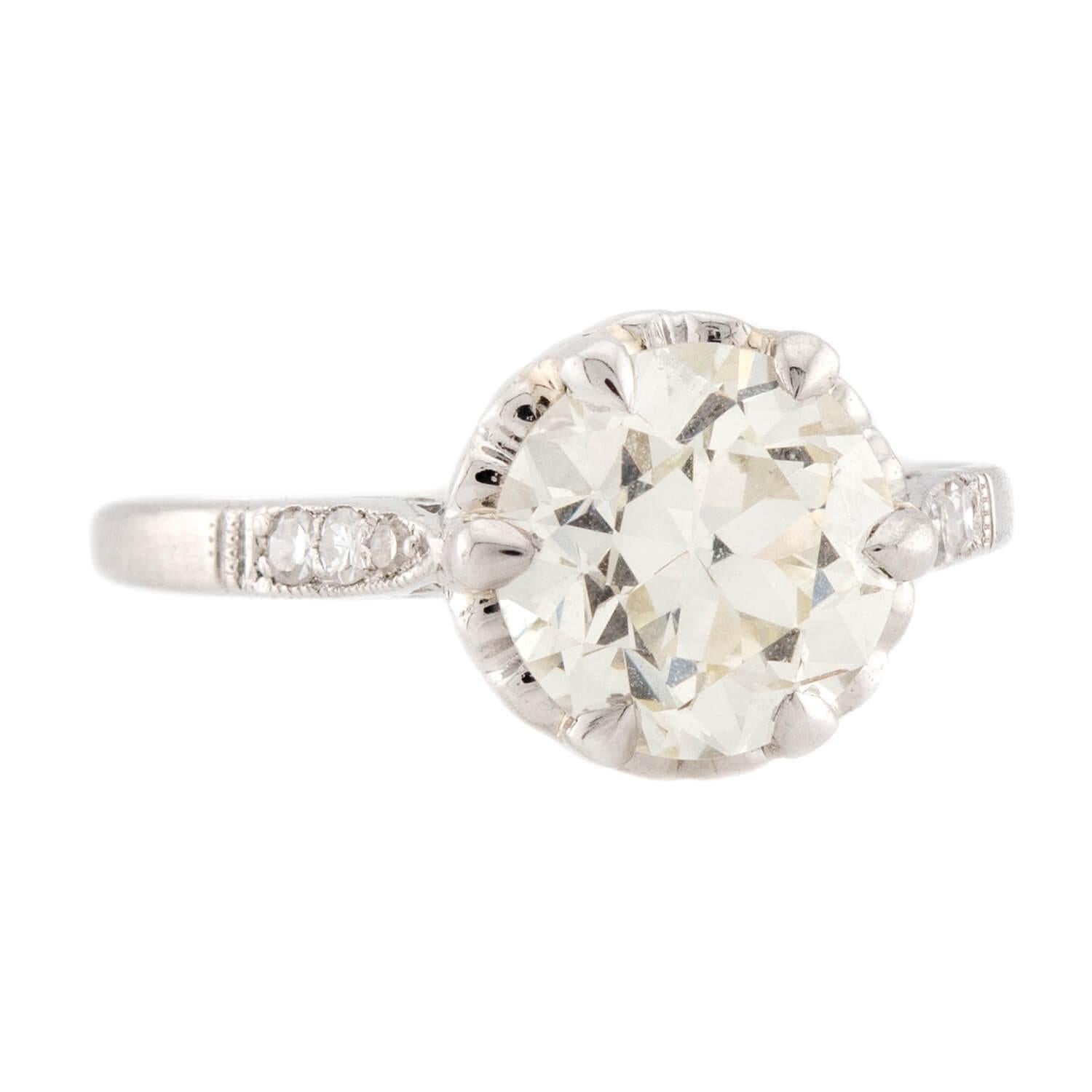 A breathtaking diamond engagement ring from the Art Deco (ca1930s) era! Crafted in platinum, this ring features a central 2.02ct old European cut diamond, which is held within a six-prong setting. The impressive stone displays L/M color and VS2
