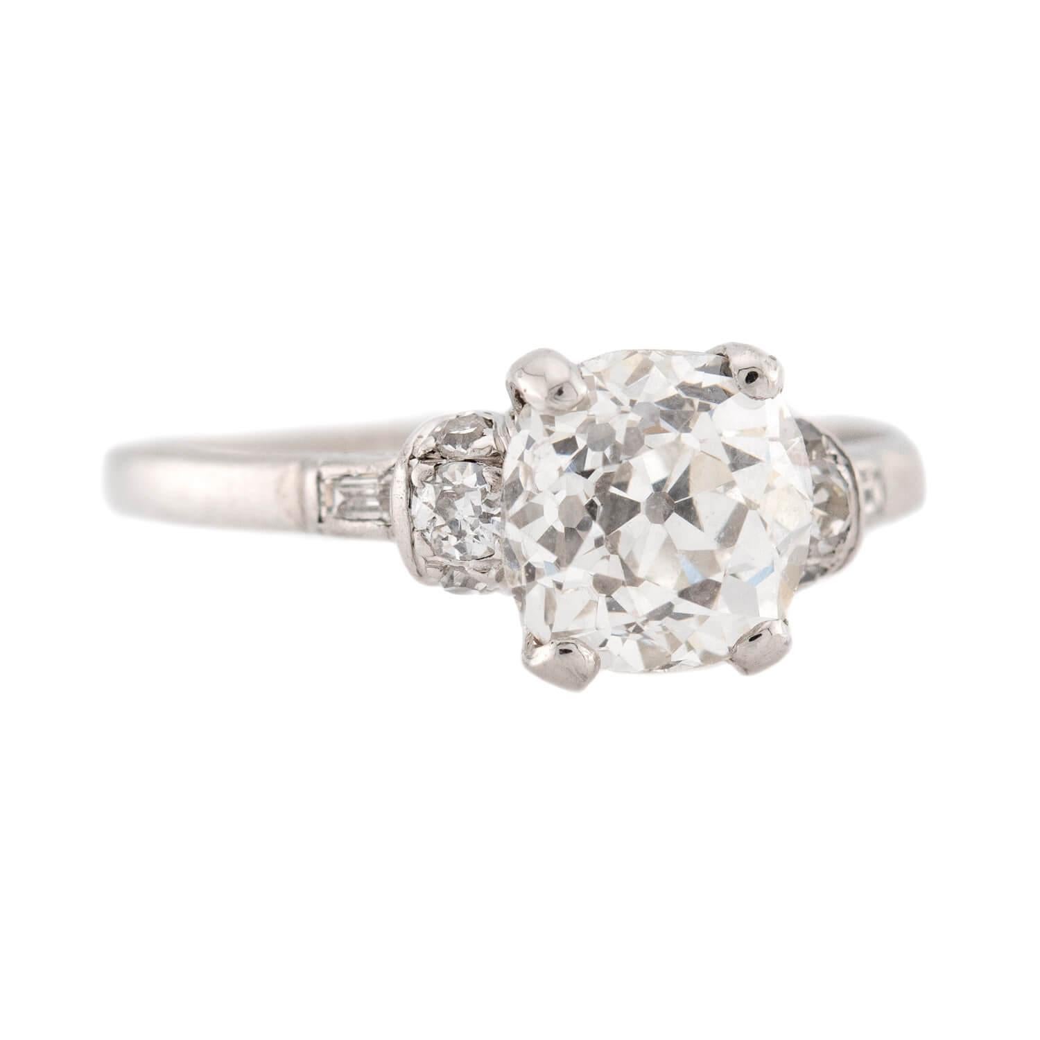 An outstanding diamond engagement ring from the Art Deco (ca1930s) era! Crafted in platinum, the ring frames a magnificent 2.68ct old mine cut cushion cut diamond held within a four-prong setting. The stone displays K/L color and SI1 clarity. Each