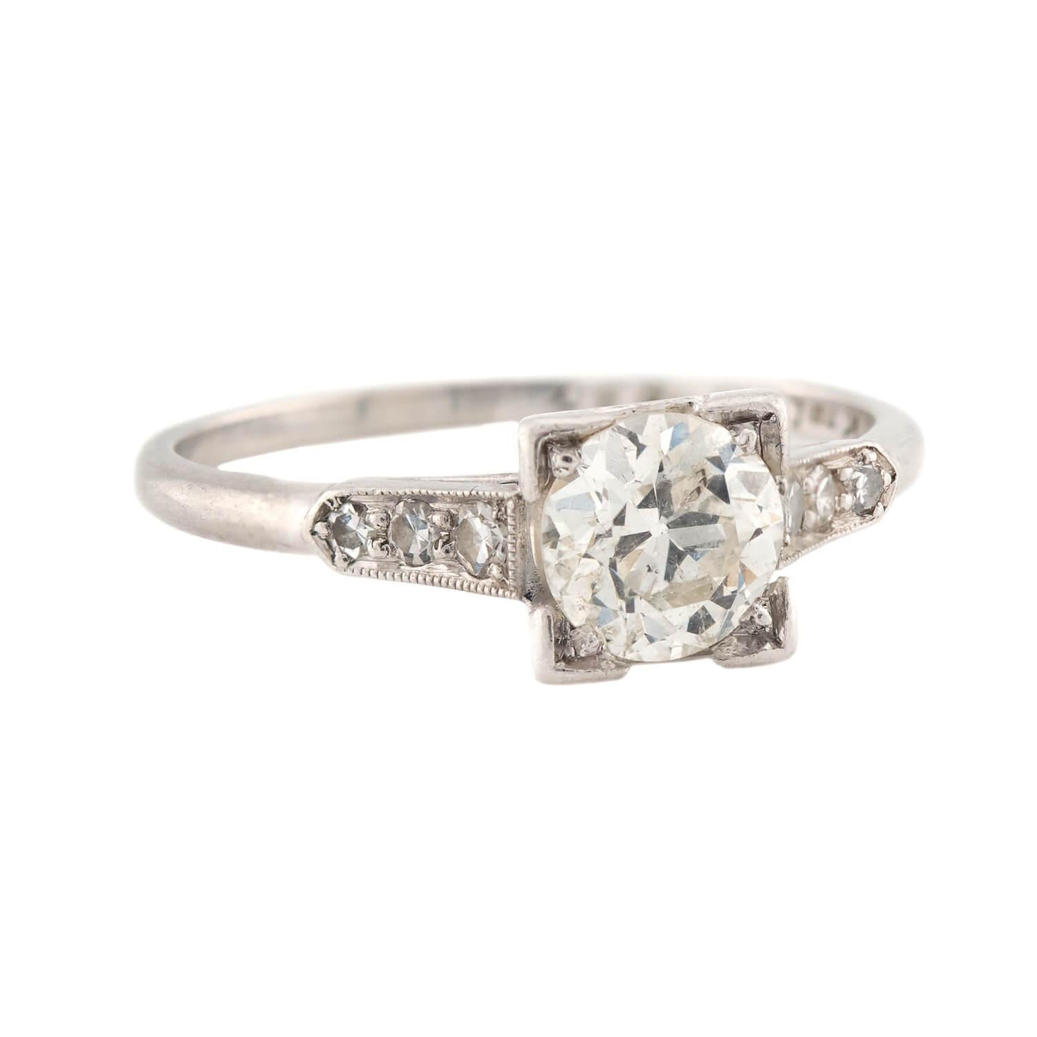 A breathtaking diamond engagement ring from the Art Deco (ca1920s) era! Crafted in platinum, this ring features a central 0.86ct old European cut diamond, which rests within a bead setting. The diamond displays I color and SI2 clarity. The shoulders