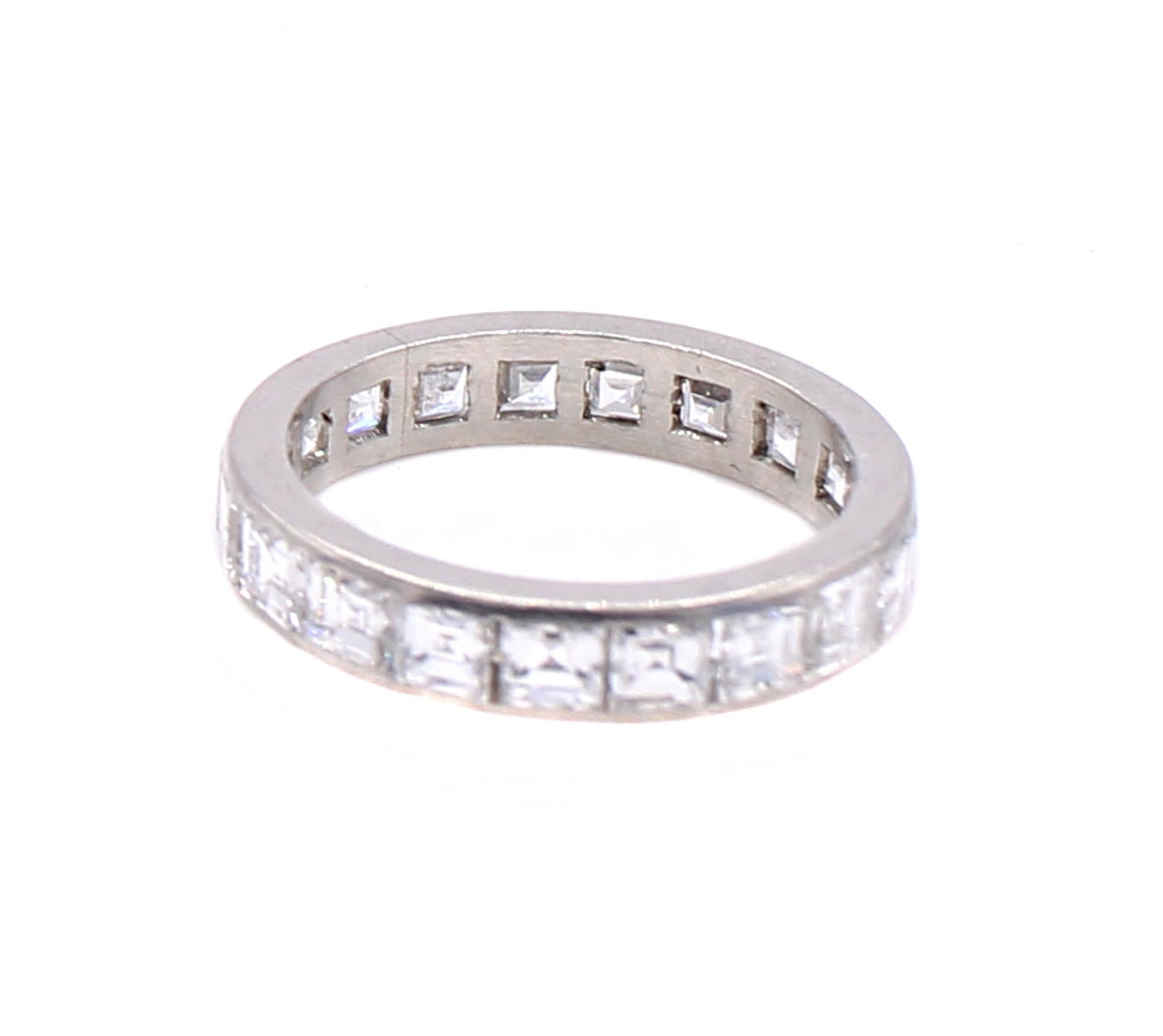 Beautifully hand crafted in platinum this Art Deco eternity band from ca 1930 is channel set with 19 perfectly matched bright white and lively square step cut diamonds The approximate total diamond weight is 3.90 carats with an average color of F-G