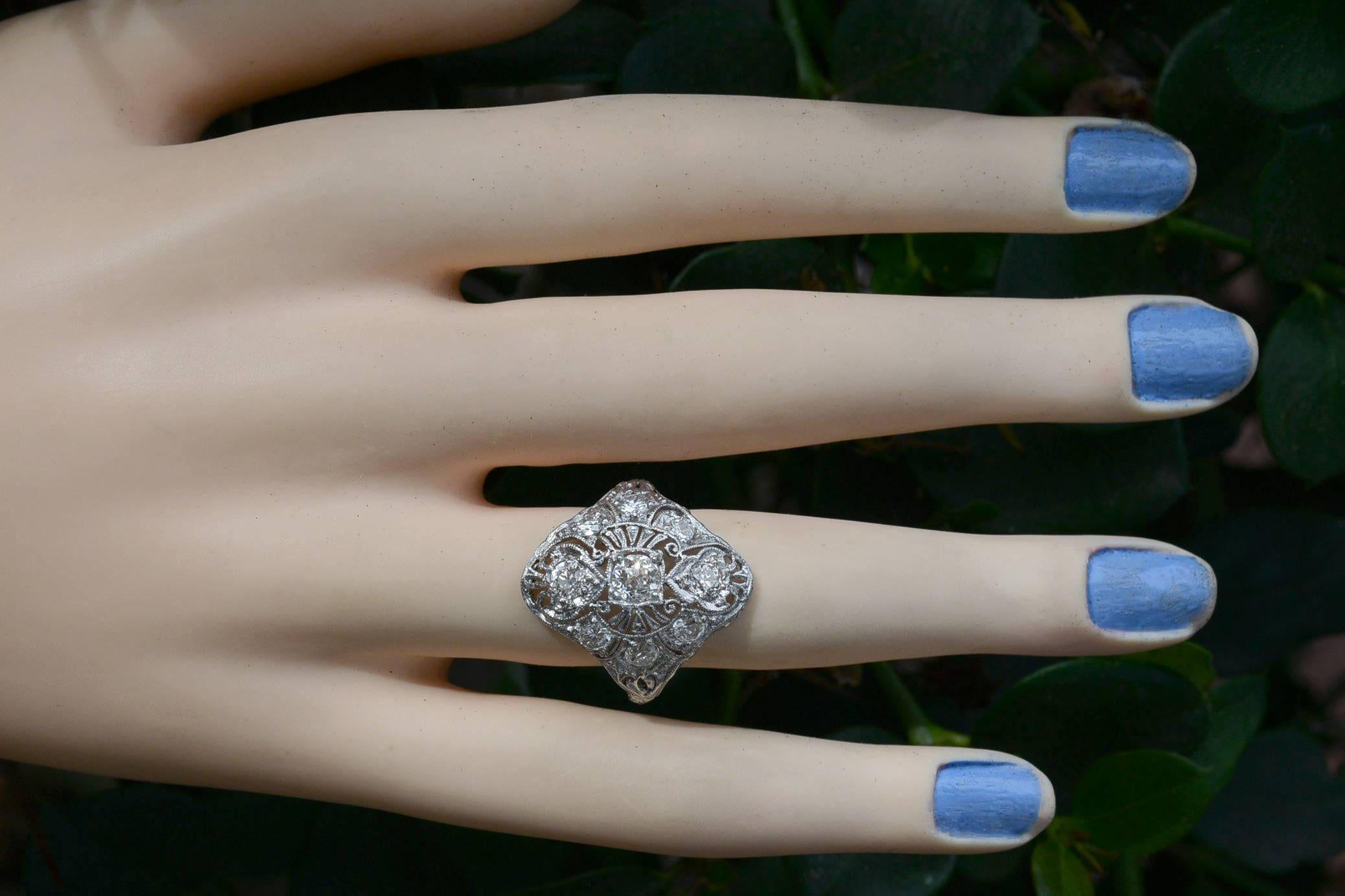 The Woodlands Antique Cocktail Ring. Featuring elements of the Edwardian era and the soon to come Art Deco period, an interesting arrangement set with 1.50 Carats of fiery old European cut diamonds in an elongated trinity design. Adorned with lacy