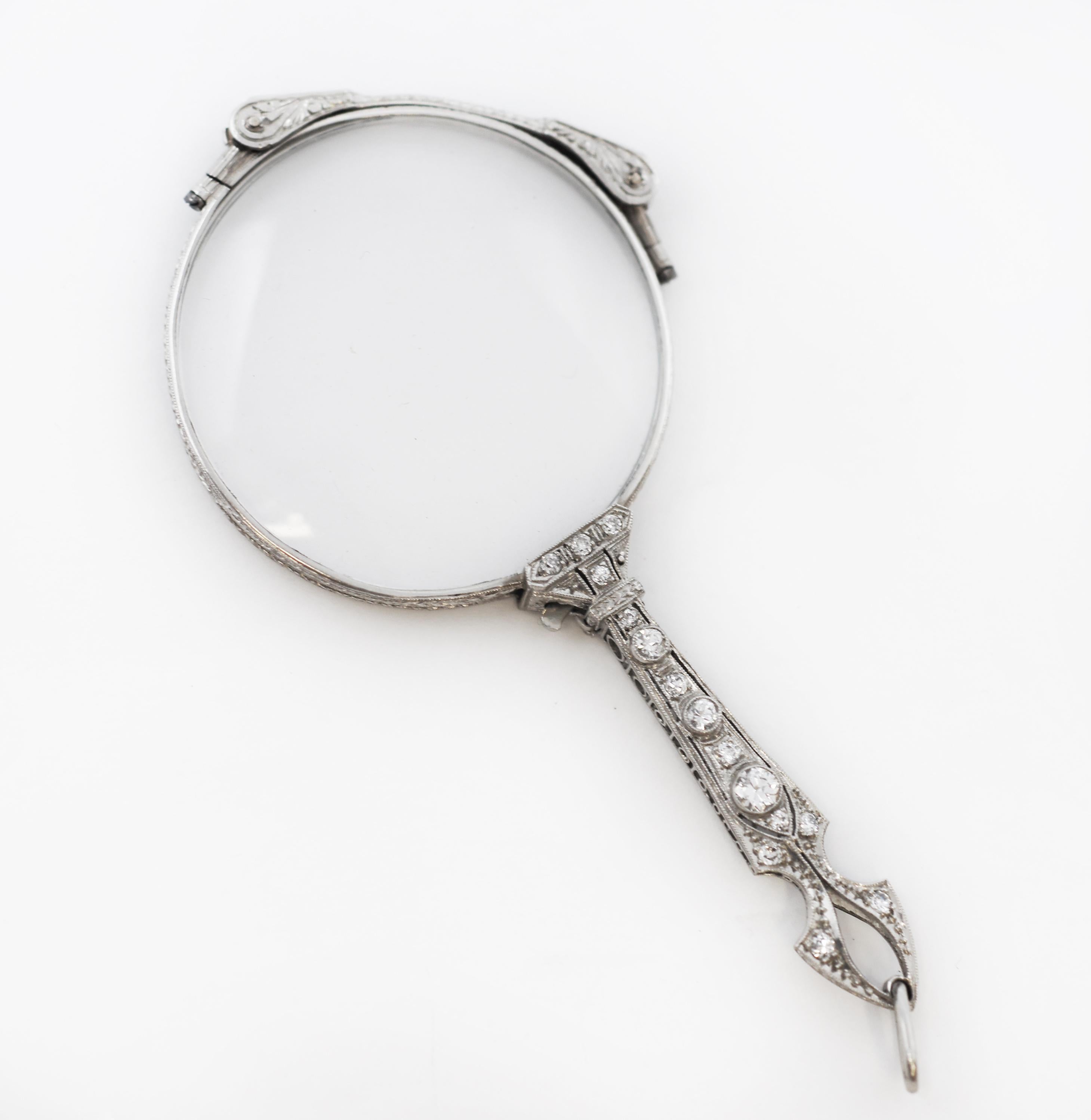 This fabulous platinum lorgnette, with it's fancy openwork handle and twinkling Diamonds. Sleek and modern Edwardian and Art Deco styles together creating a stylish pieces that still found room for the fine forms and lines of previous eras within