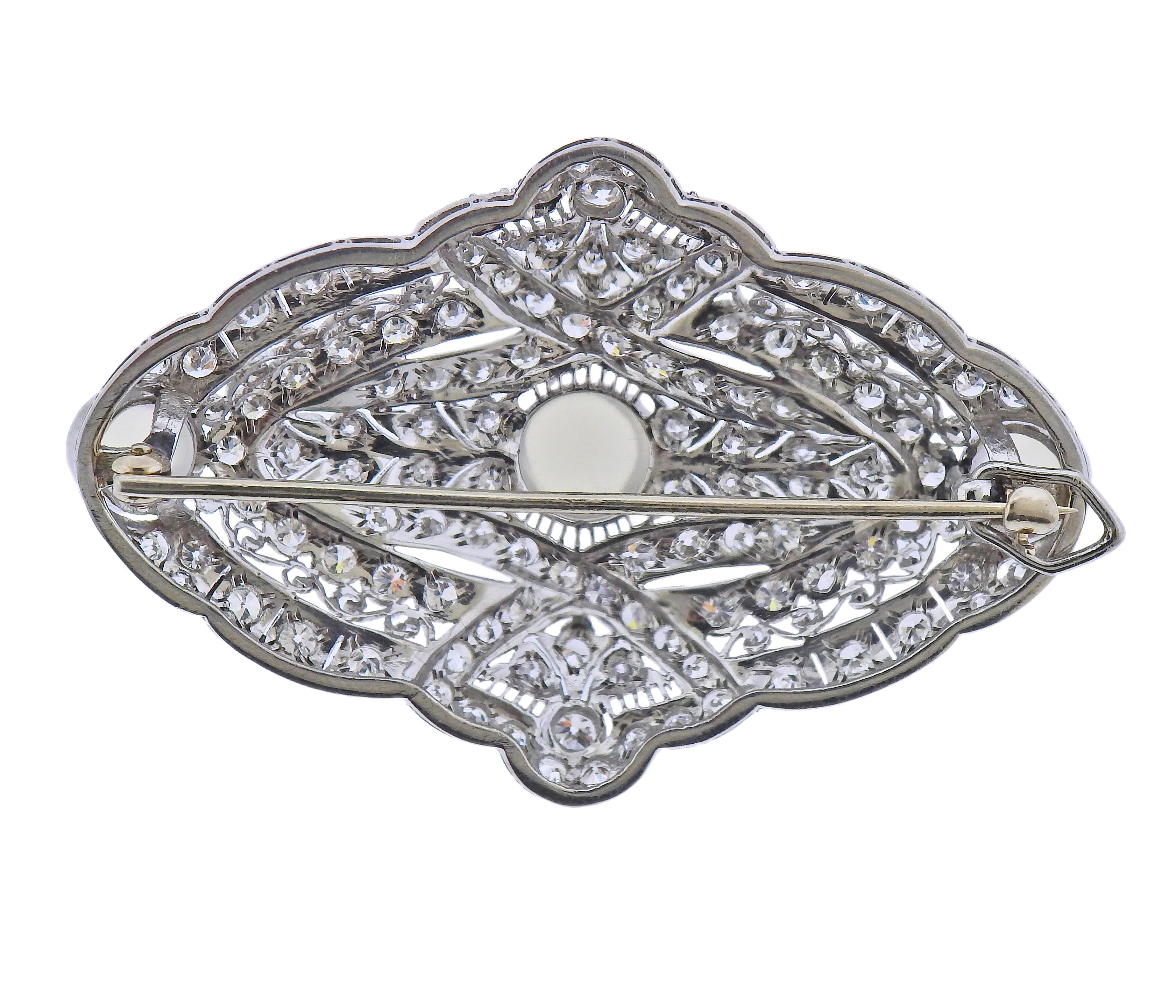 Platinum Art Deco brooch/pendant, set with 3 moonstones - 6.6mm to 8.5mm, surrounded with approx. 3.50ctw in diamonds. Brooch measures 56mm x 36mm. Tested plat. Weight - 21.6 grams.