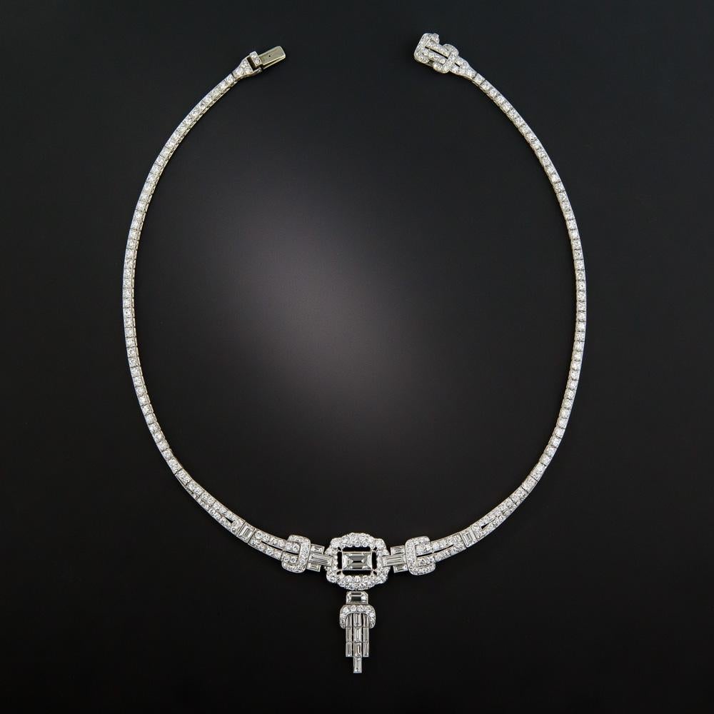 Fit for a formidable modern day flapper, this superb and stunning, quintessential Art Deco necklace, hand fabricated in platinum, circa 1920s-30s, is elegantly designed around a central emerald-cut diamond (actually a very large Carré-cut or