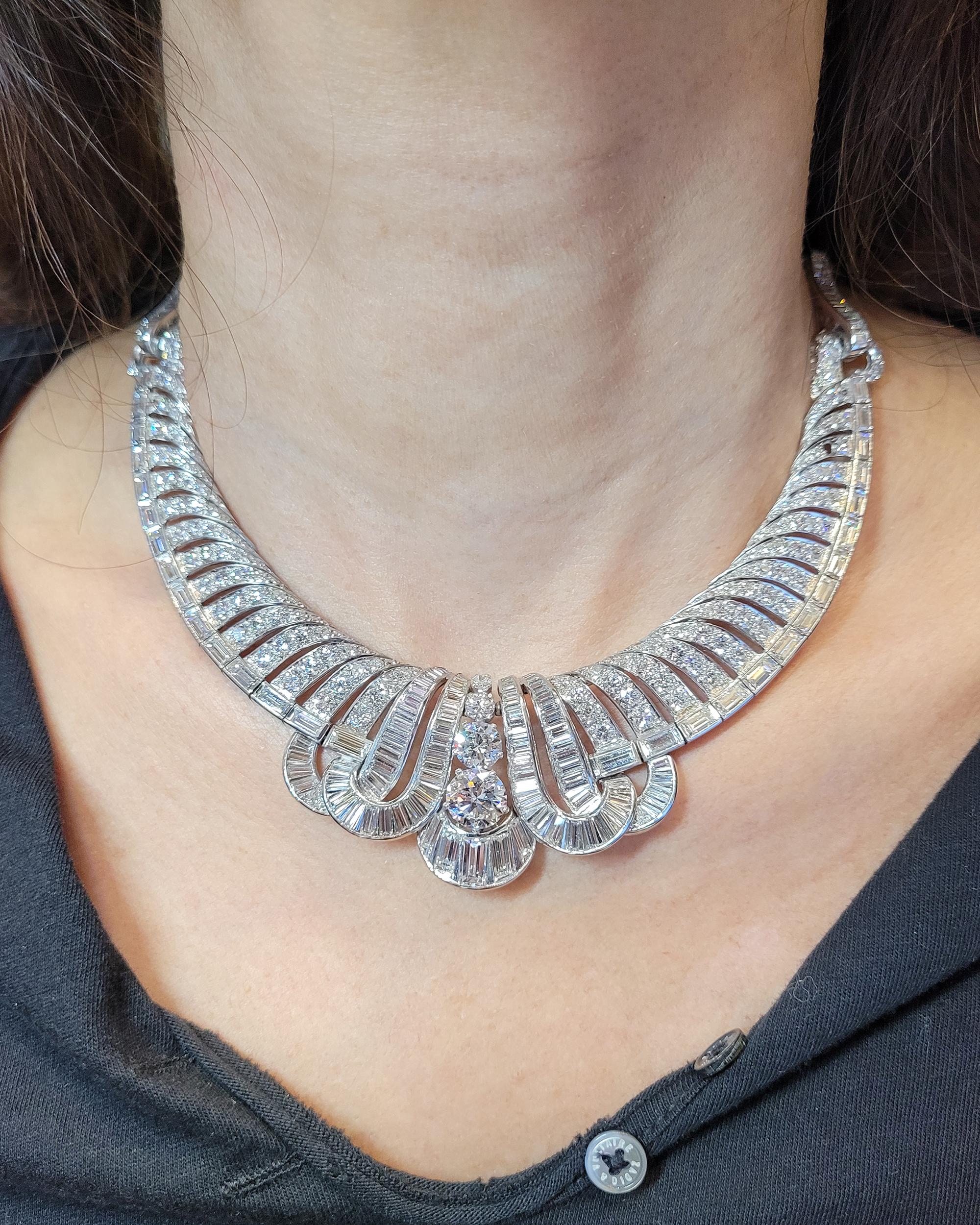 A stunning necklace from the Art Deco period, comprising of circular and baguette-cut diamonds, weighing a total of 52 carats. 
The diamonds are E-F-G color, VS clarity.
Metal is platinum.
Gross weight is 67.25 gr
13 3/4 ins long (35 cm).
Circa