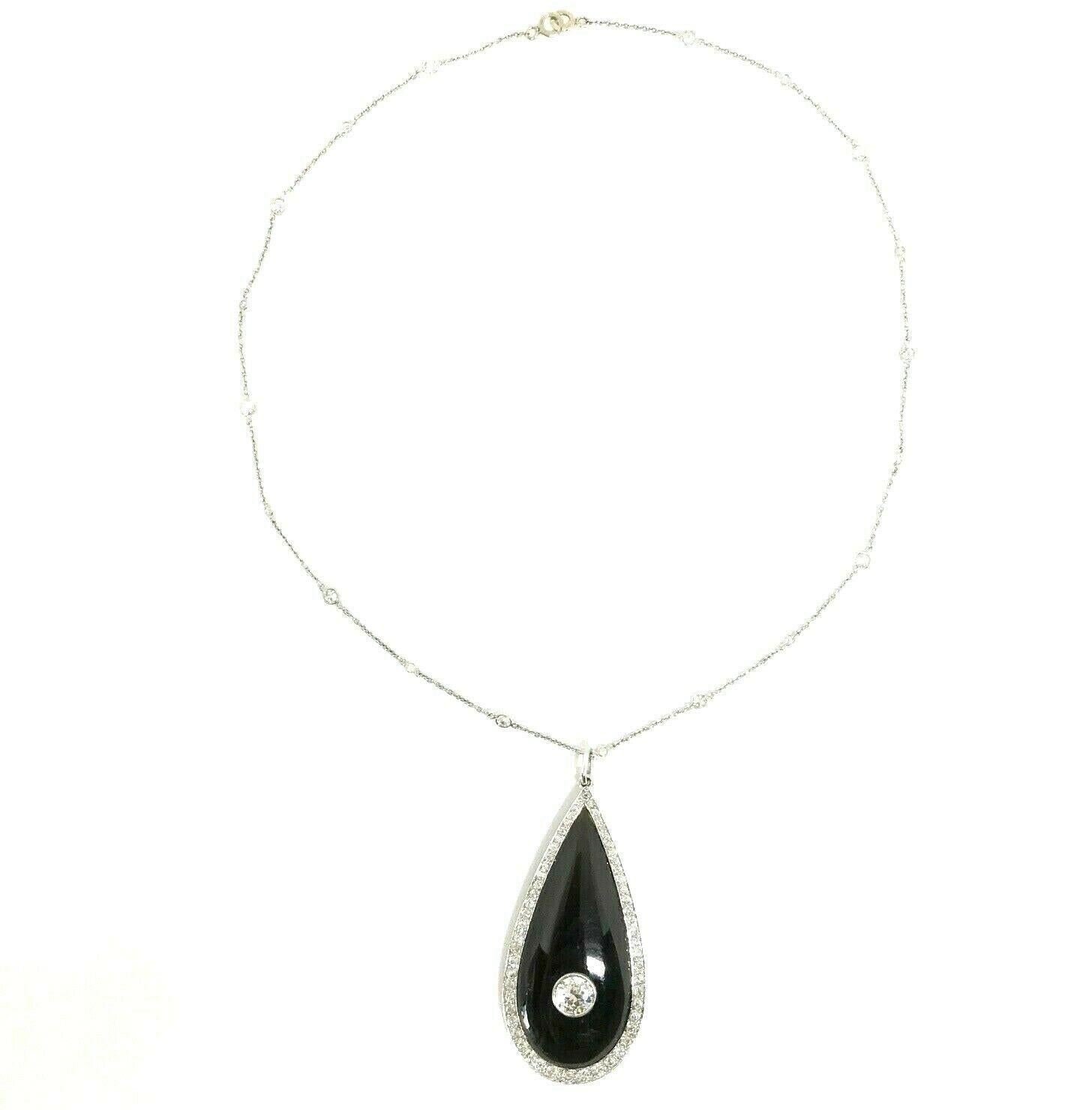 Beautiful Art Deco platinum diamond chain necklace with an onyx locket pendant. 
The center diamond is Old European cut about 1.30 carats, I color VS2 clarity. Surrounded by approximately 2 carats of the single cut I color VS2 clarity diamonds. The