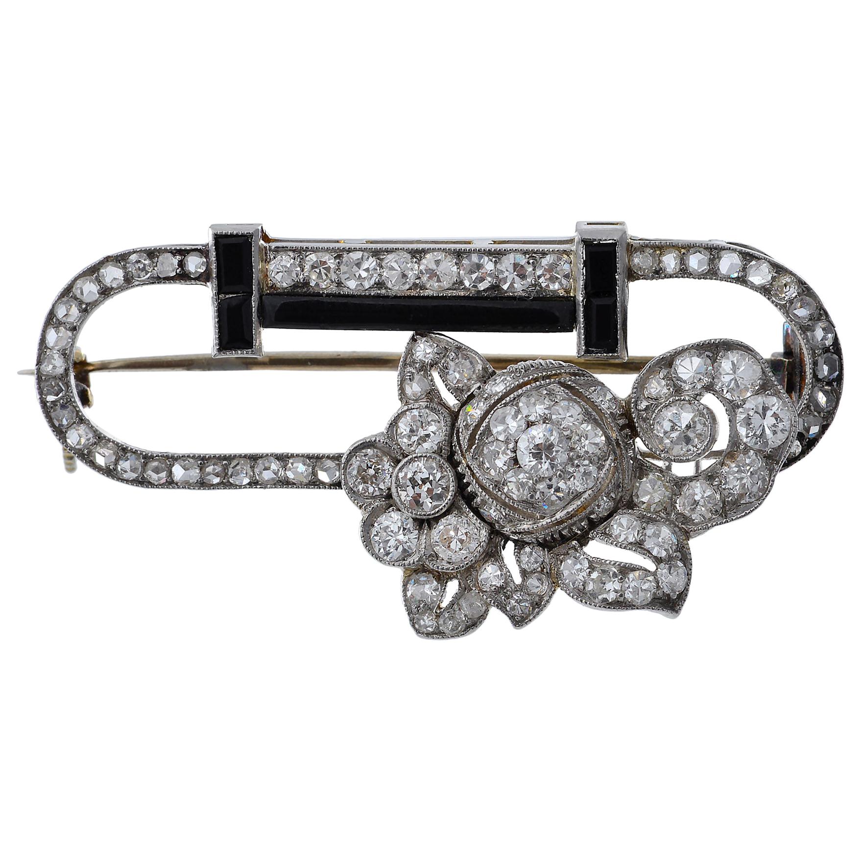 Art Deco Platinum, Diamond, Onyx and Diamond Stylized Brooch For Sale