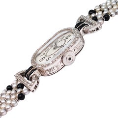 Montre-bracelet mécanique Art déco pour femme en platine, diamants, perles et onyx