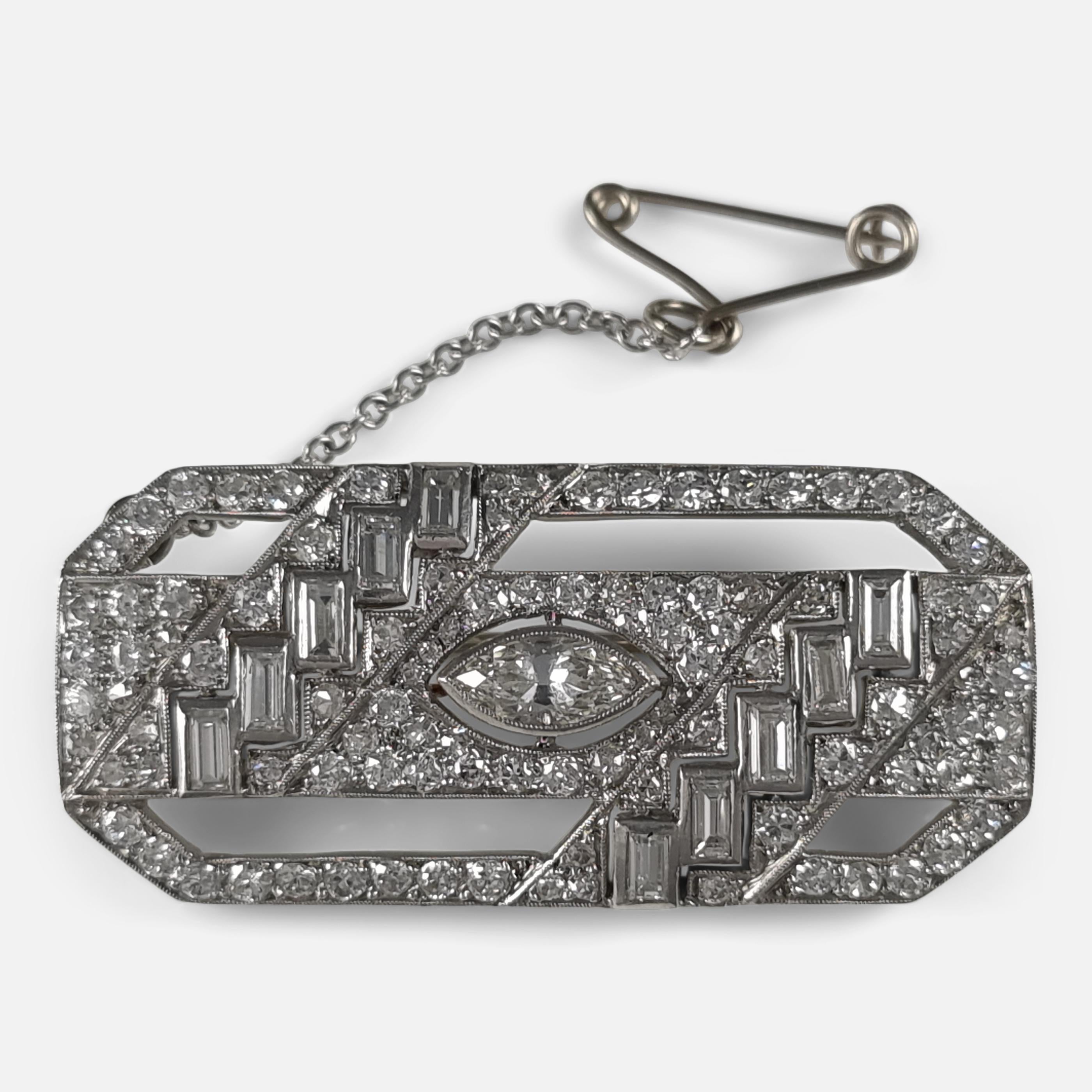 An Art Deco period platinum diamond brooch.  The art deco style brooch is set with a central marquise cut diamond weighing approximately 0.37ct within a platinum rectangular surmount set throughout with a further 102 diamonds totaling approximately