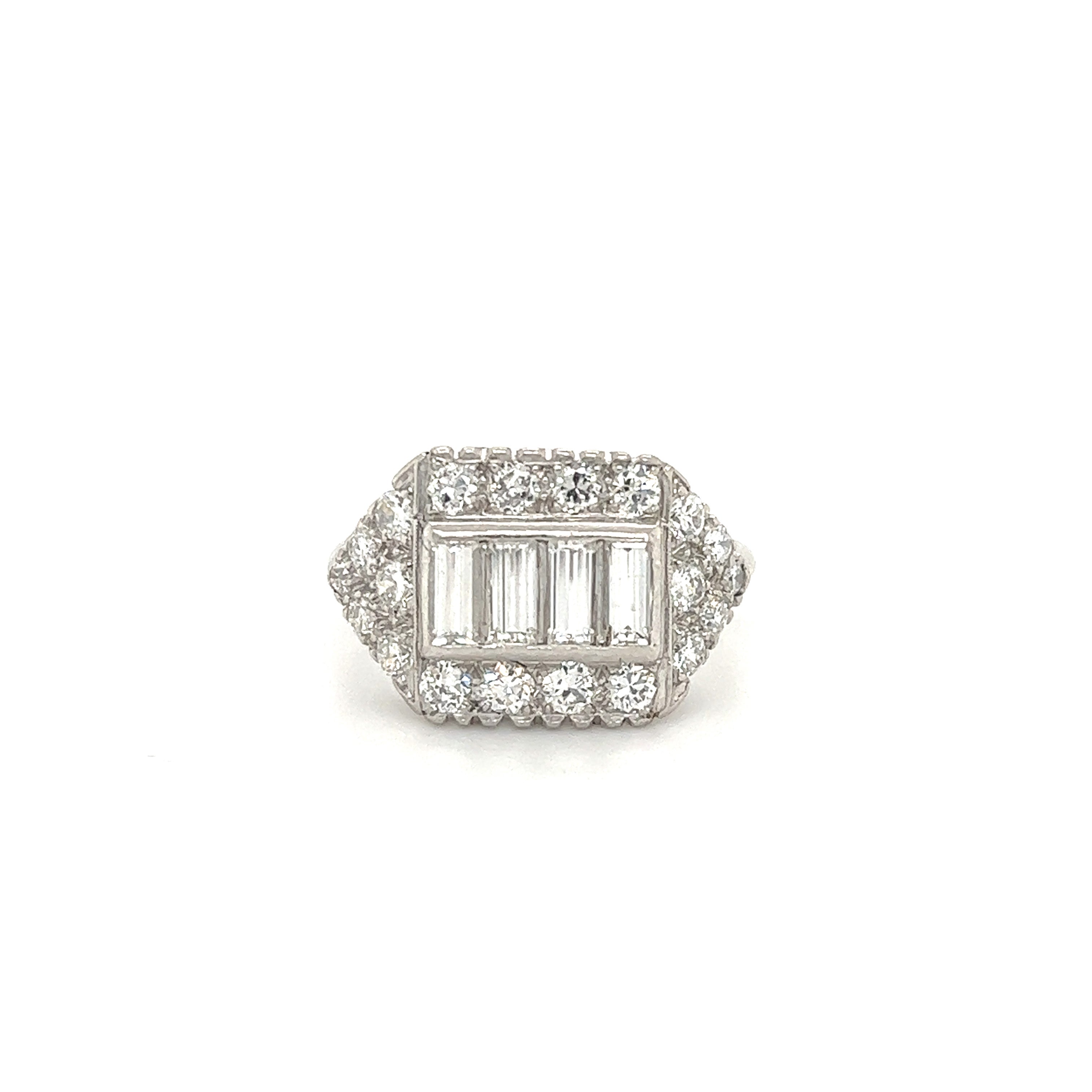 Gorgeous hand made art deco ring crafted in platinum.  The ring showcases straight baguette cut diamonds in the center. These diamonds truly highlight the ring, these step cut diamonds each weigh approximately 0.20 ct and show F-G color with VVS