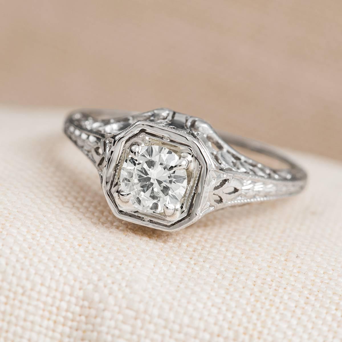 Platinum engagement ring with round brilliant diamond .51 carats total weight featuring an M color and SI2 clarity. Pierced and engraved shank. Size 6 and can be sized up or down complimentary with purchase