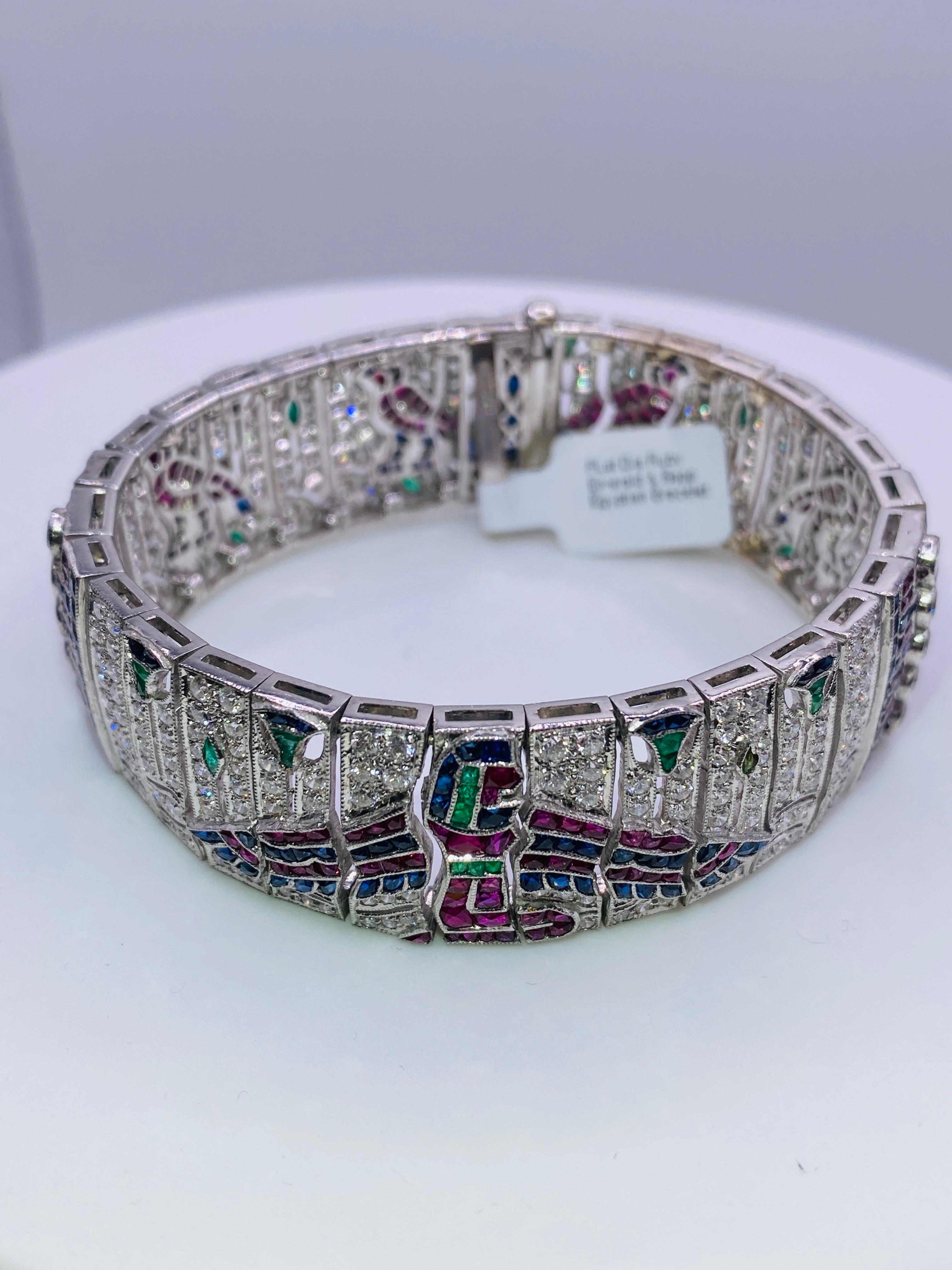 Art Deco Platinum Egyptian themed bracelet with approximately 5 carat total weight diamonds as well as rubies, sapphires and emeralds. 7” bracelet 