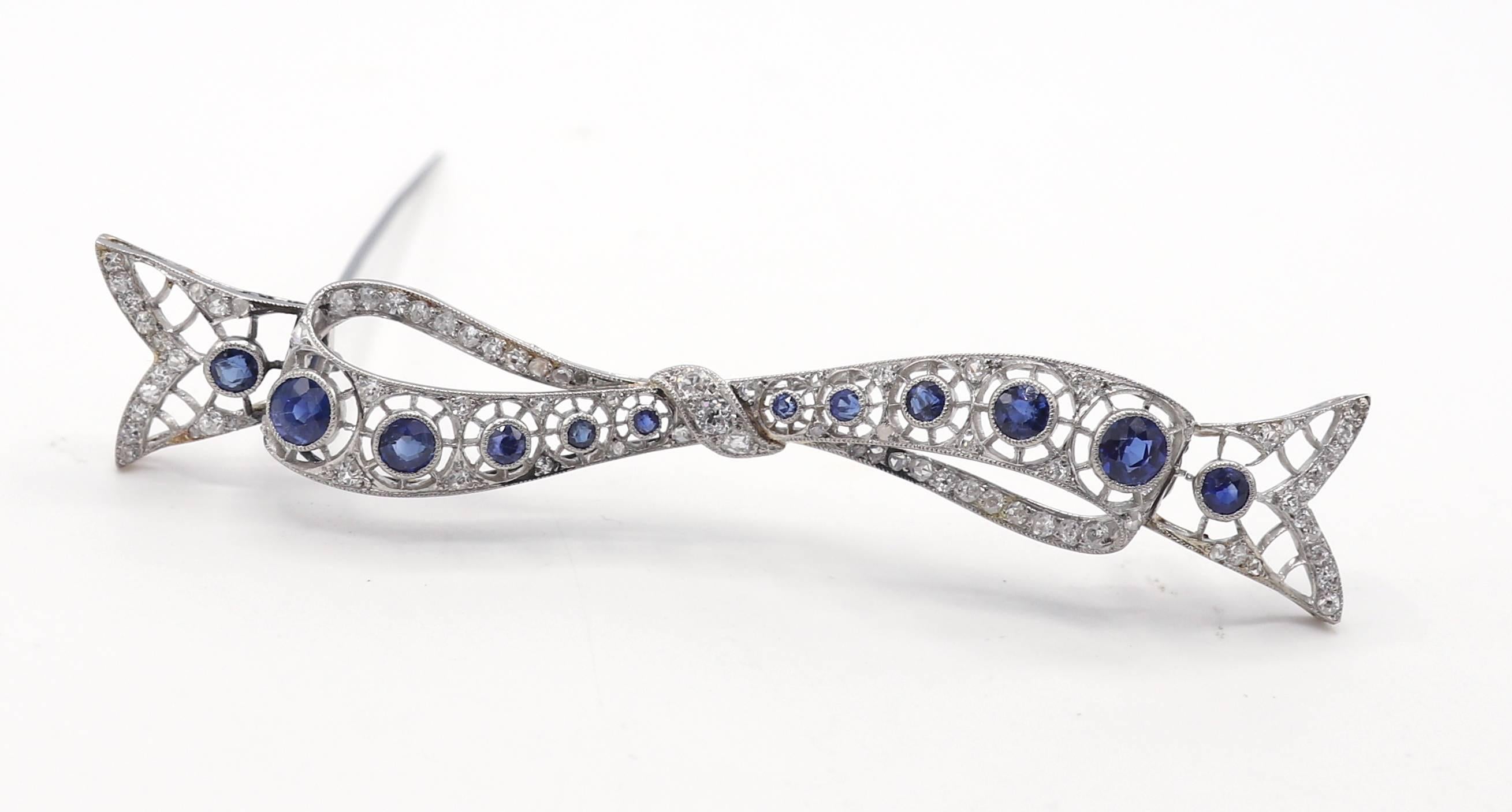 Art Deco Platinum Natural Diamond & Sapphire Bow Brooch Pin
Metal: Platinum
Weight: 12.47 grams
Diamonds: Approx. 1 CTW G-H European and mine cut natural diamonds
Length: 3 inches
Width: 0.5 inch

